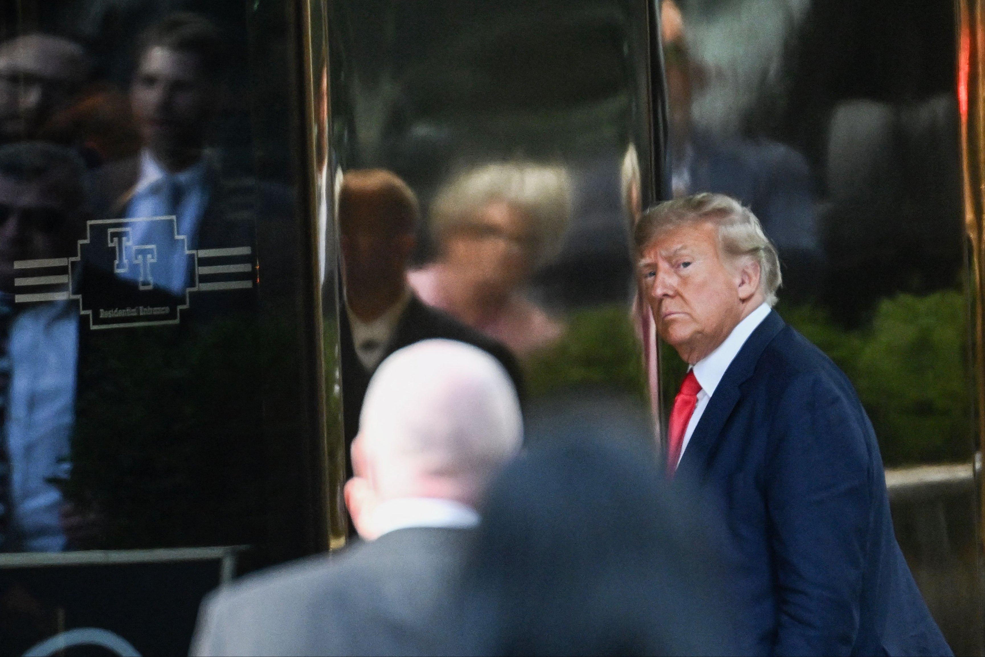 Former US president Donald Trump walking into Trump Tower in New York in April. The fraud lawsuit against him risks bringing down his business empire