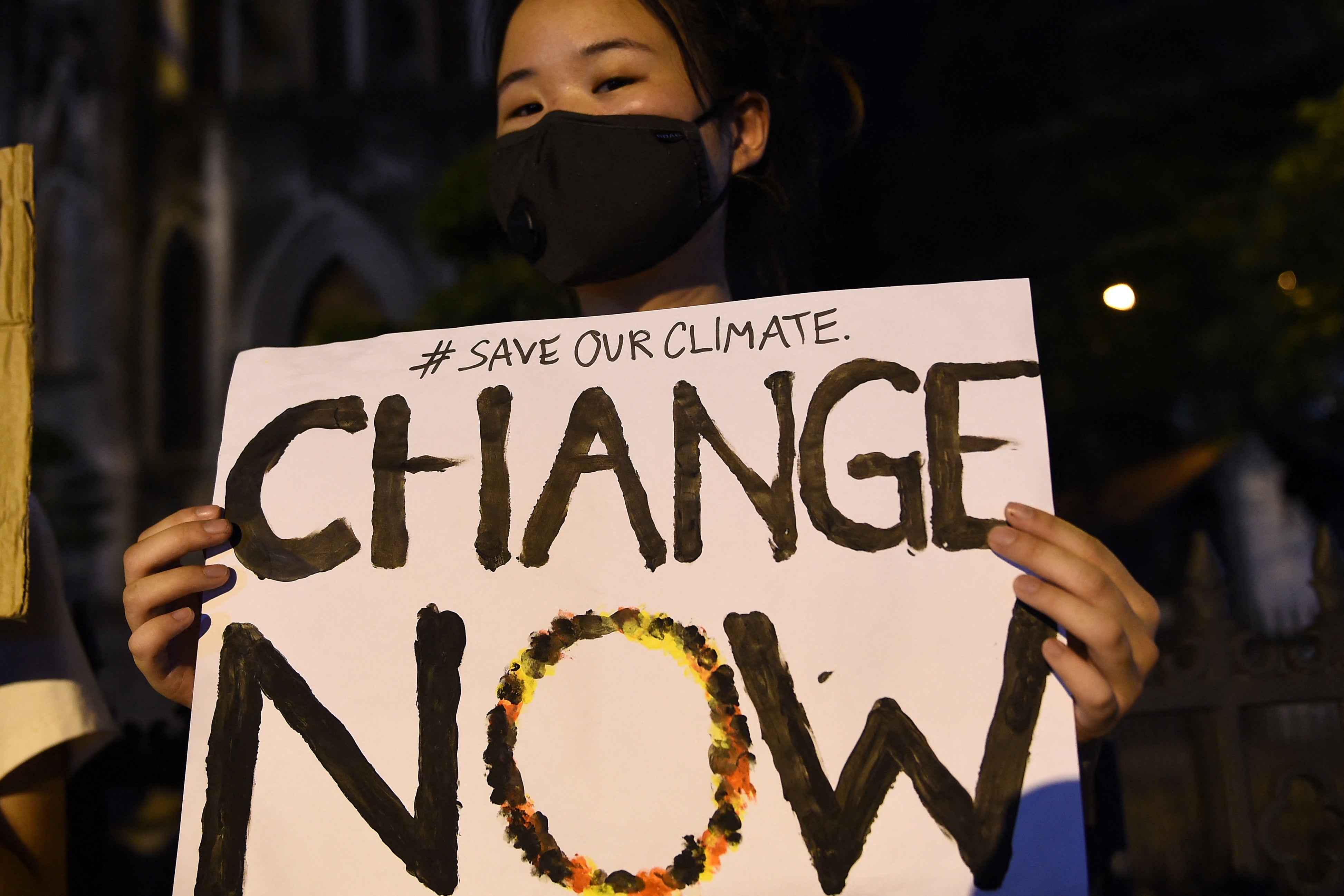 Activists hold placards during a demonstration as part of the global climate strike week in Hanoi