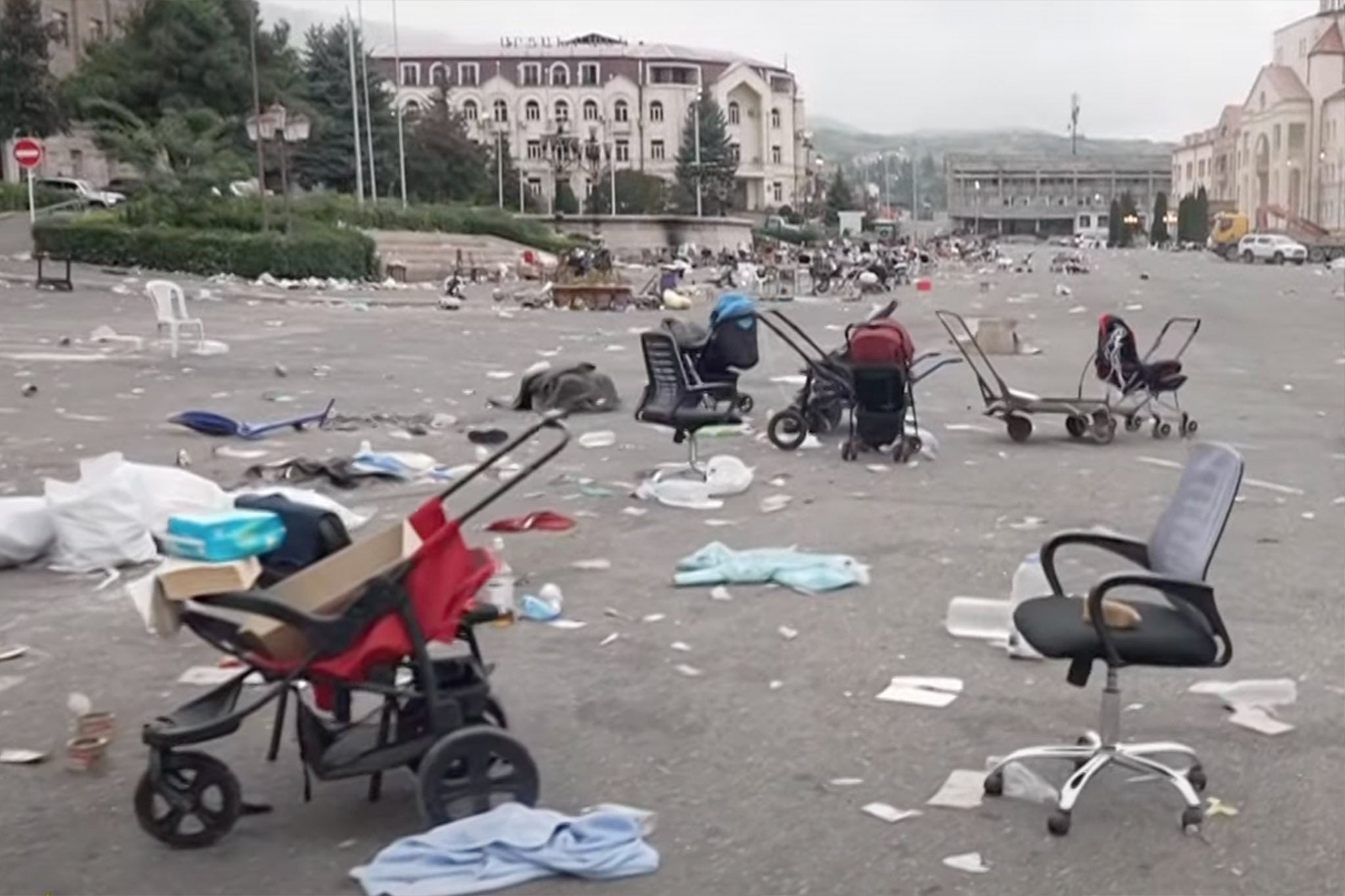 Prams and trolleys are abandoned in the street where residents waited to board buses