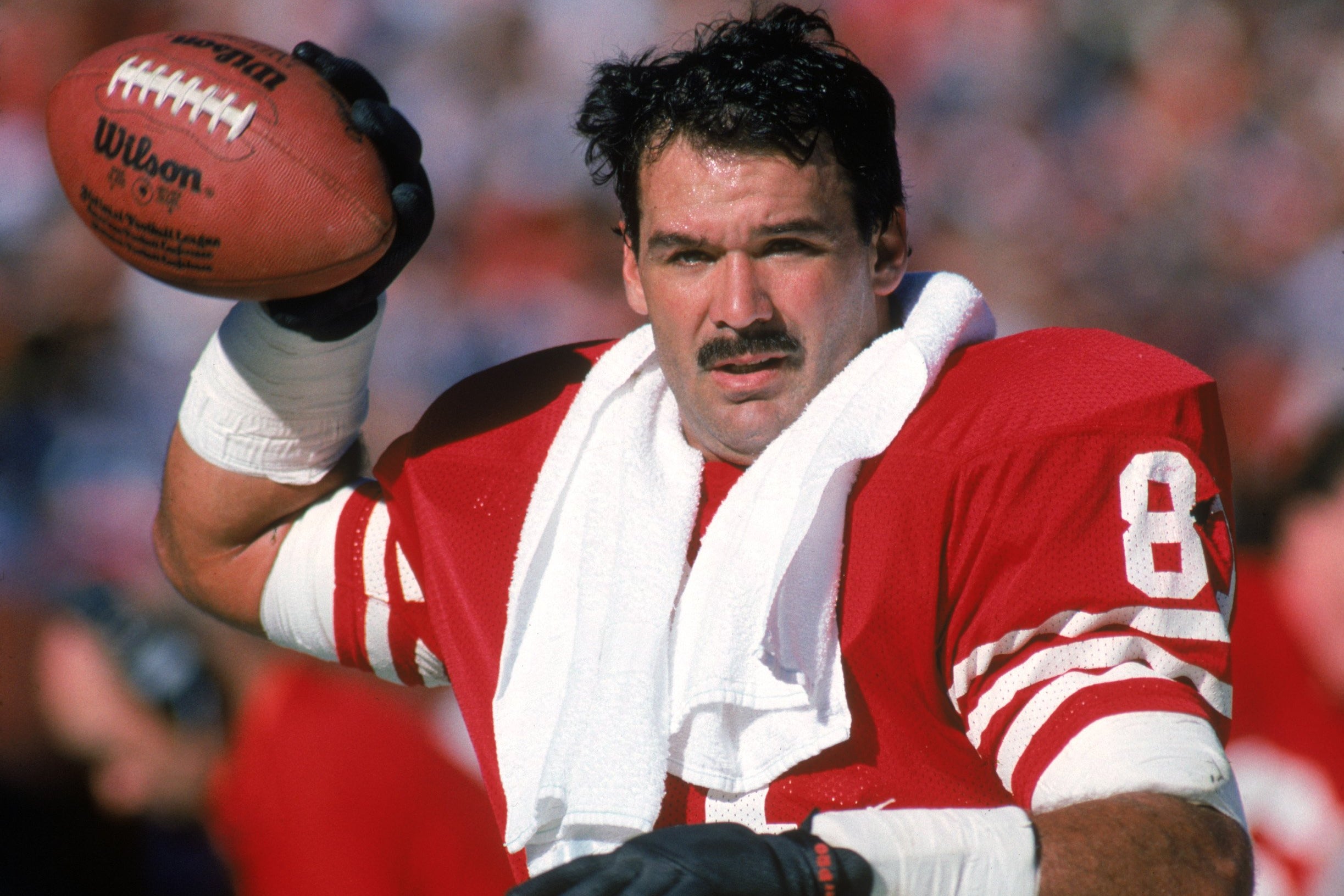 Russ Francis of the San Francisco 49ers warms-up on the sideline during a game against the New Orleans Saints in 1987