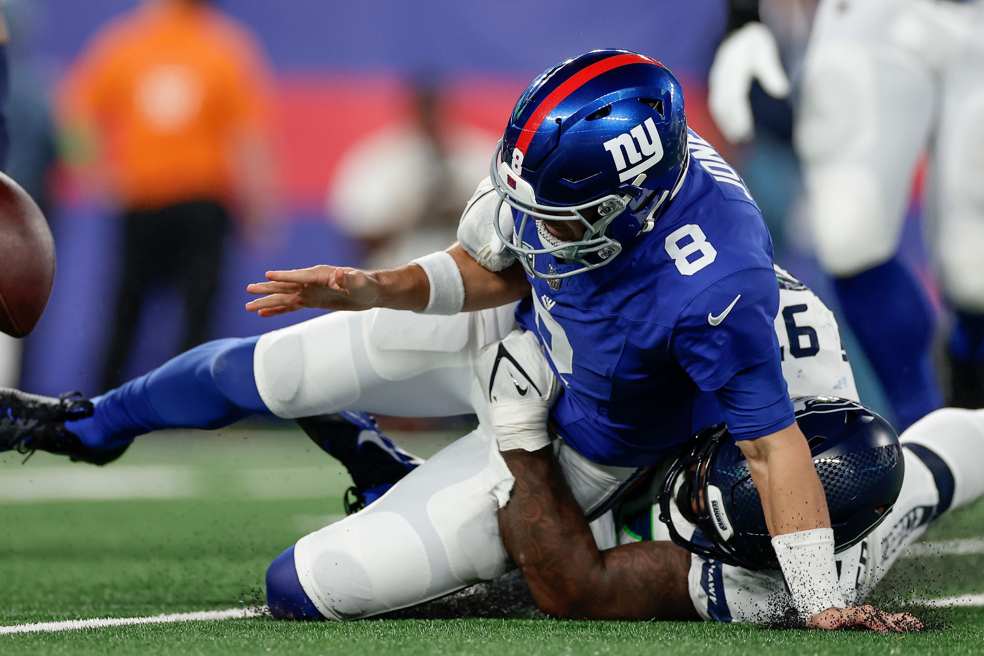 New York Giants quarterback Daniel Jones fumbles the ball as he is tackled by Seattle Seahawks defensive end Mario Edwards Jr (Adam Hunger/AP)