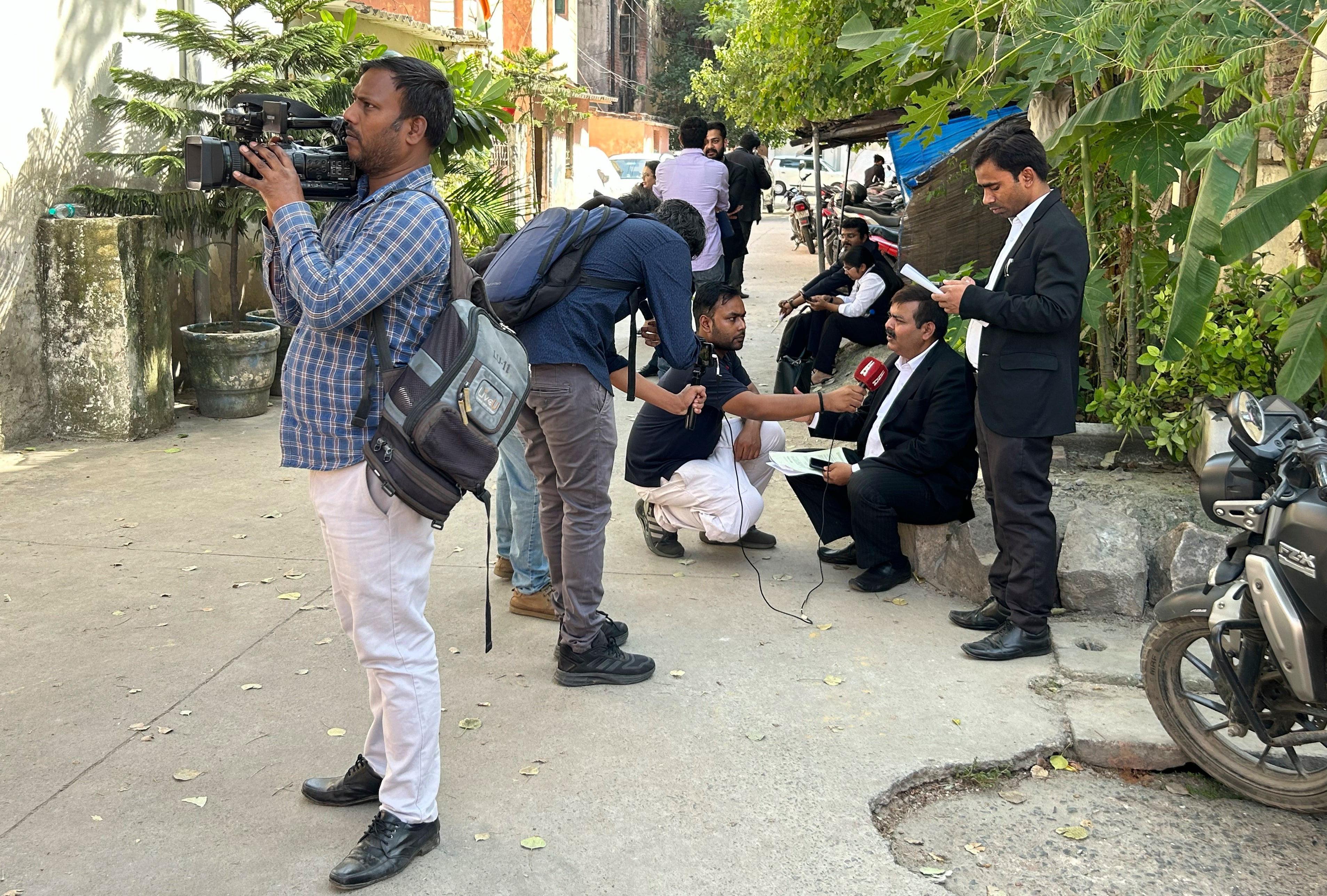 Journalists speak to lawyers outside the office of Delhi Police’s Special Cell in New Delhi, India, Tuesday, 3 October 2023