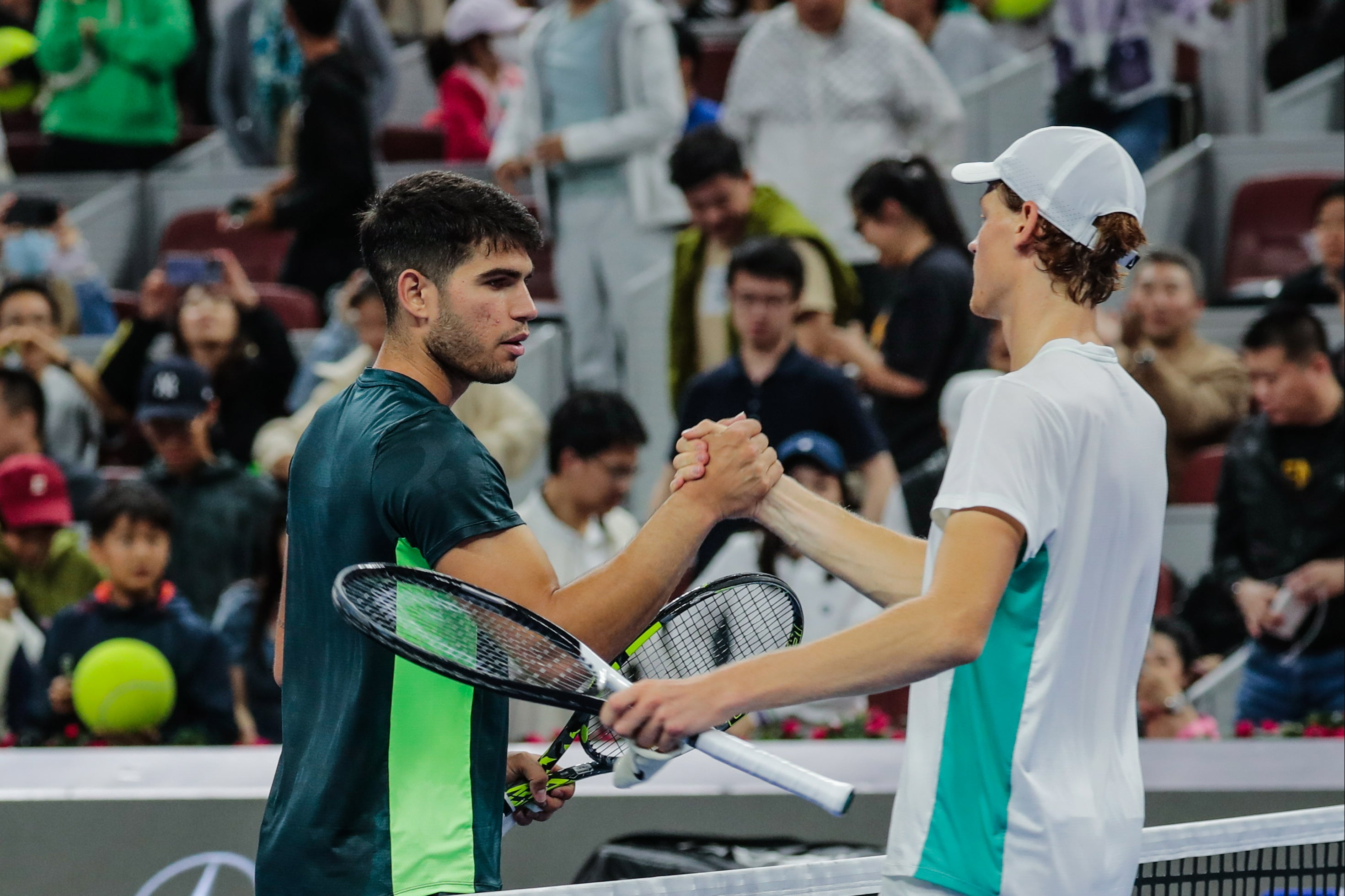 Jannik Sinner shakes hands with Carlos Alcaraz