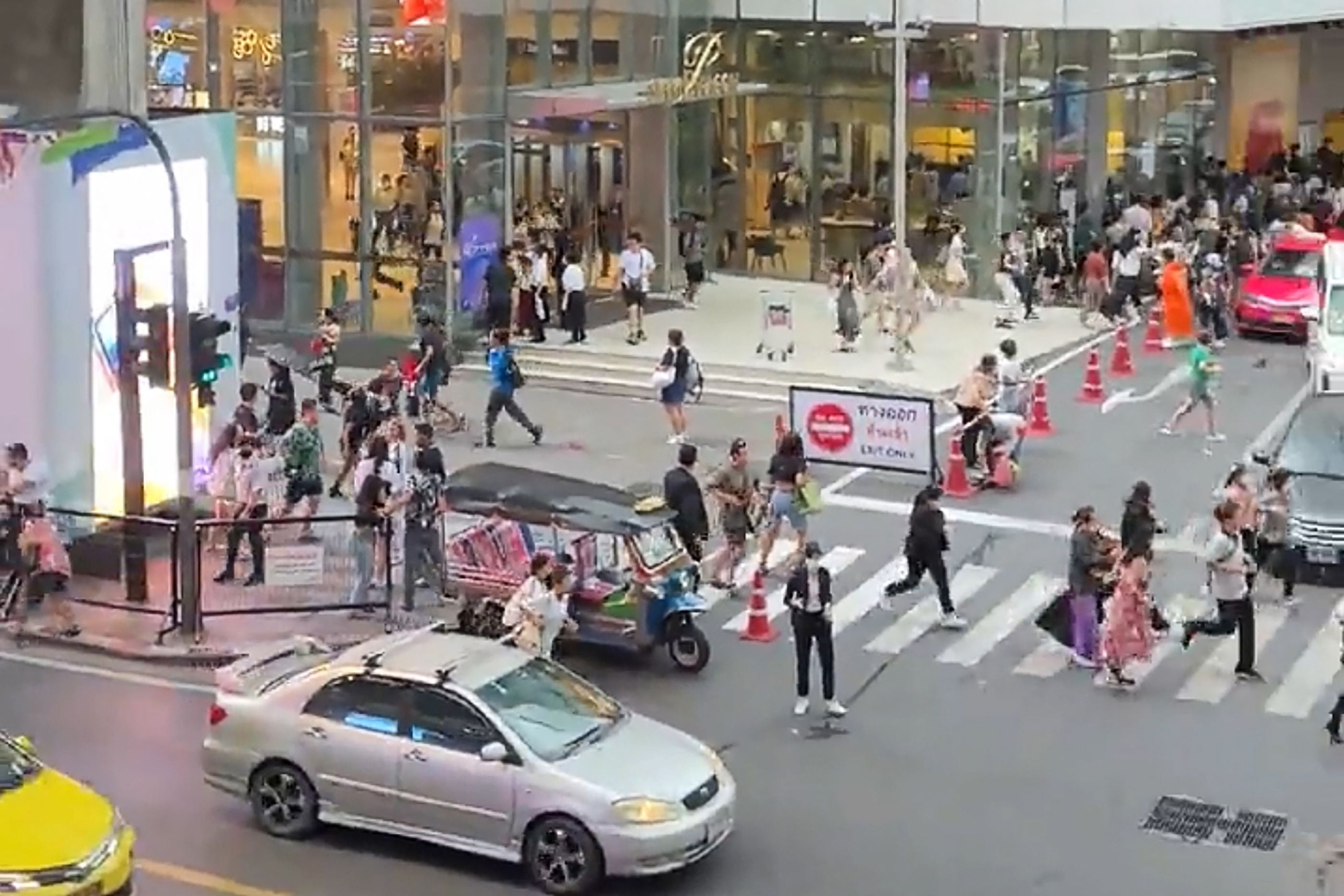 People running out of Siam Paragon shopping centre in Bangkok