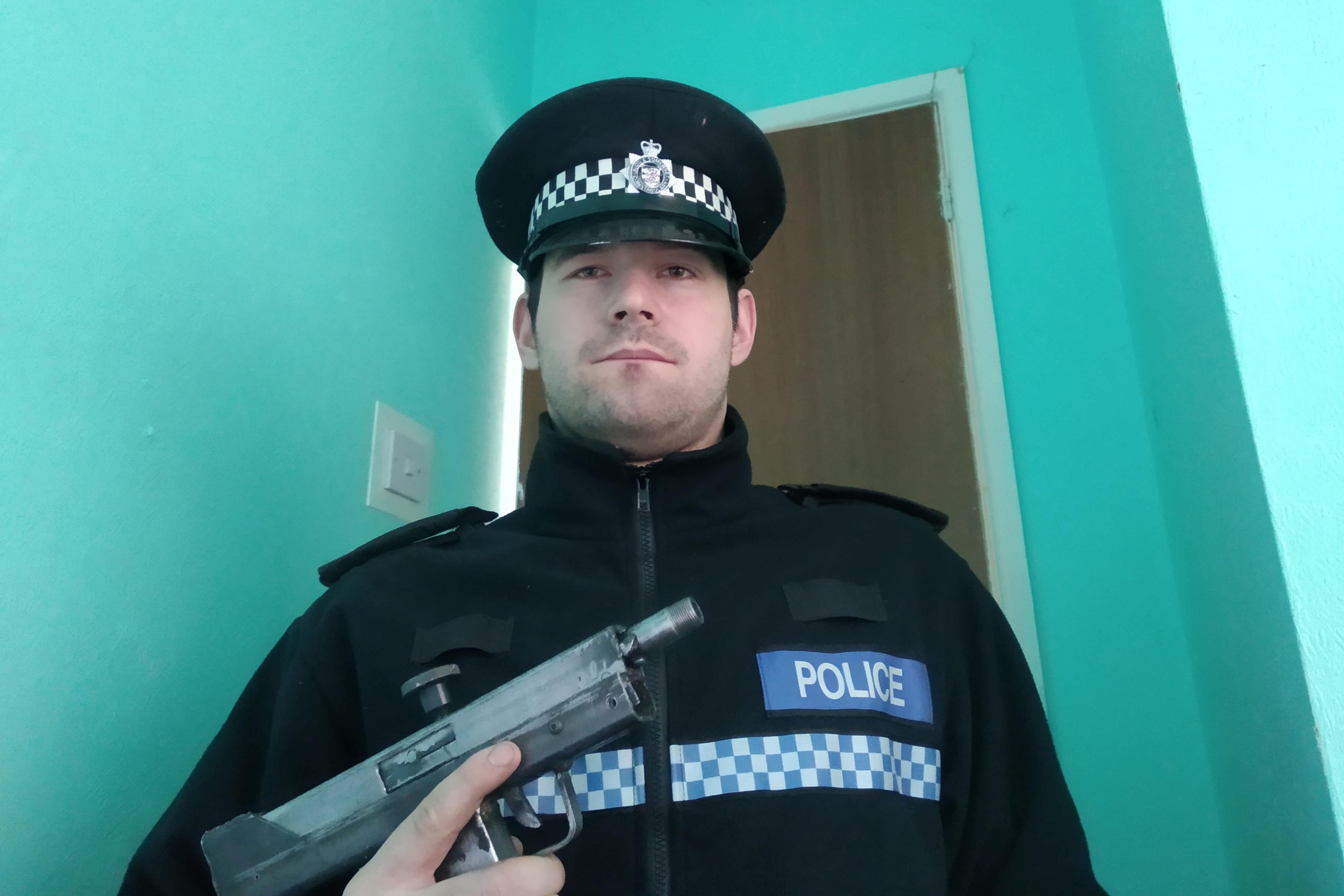 Reed Wischhusen in a police uniform and holding a firearm (Avon and Somerset Police/PA)