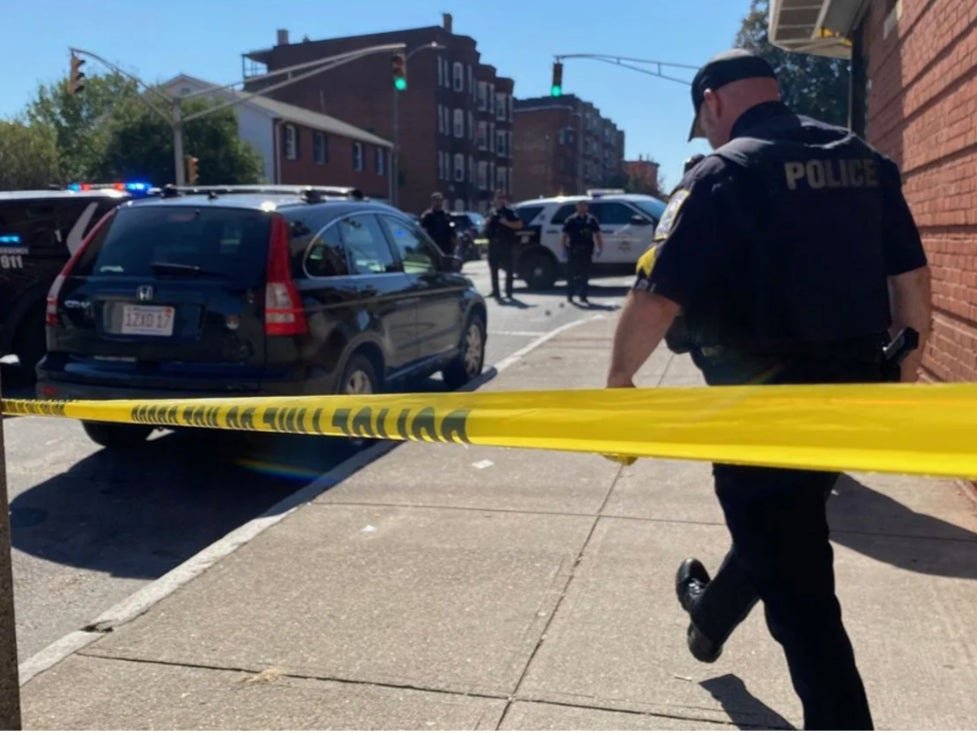 A Holyoke police officer responds to a shooting with multiple victims in a downtown neighborhood of Holyoke, Massachusetts