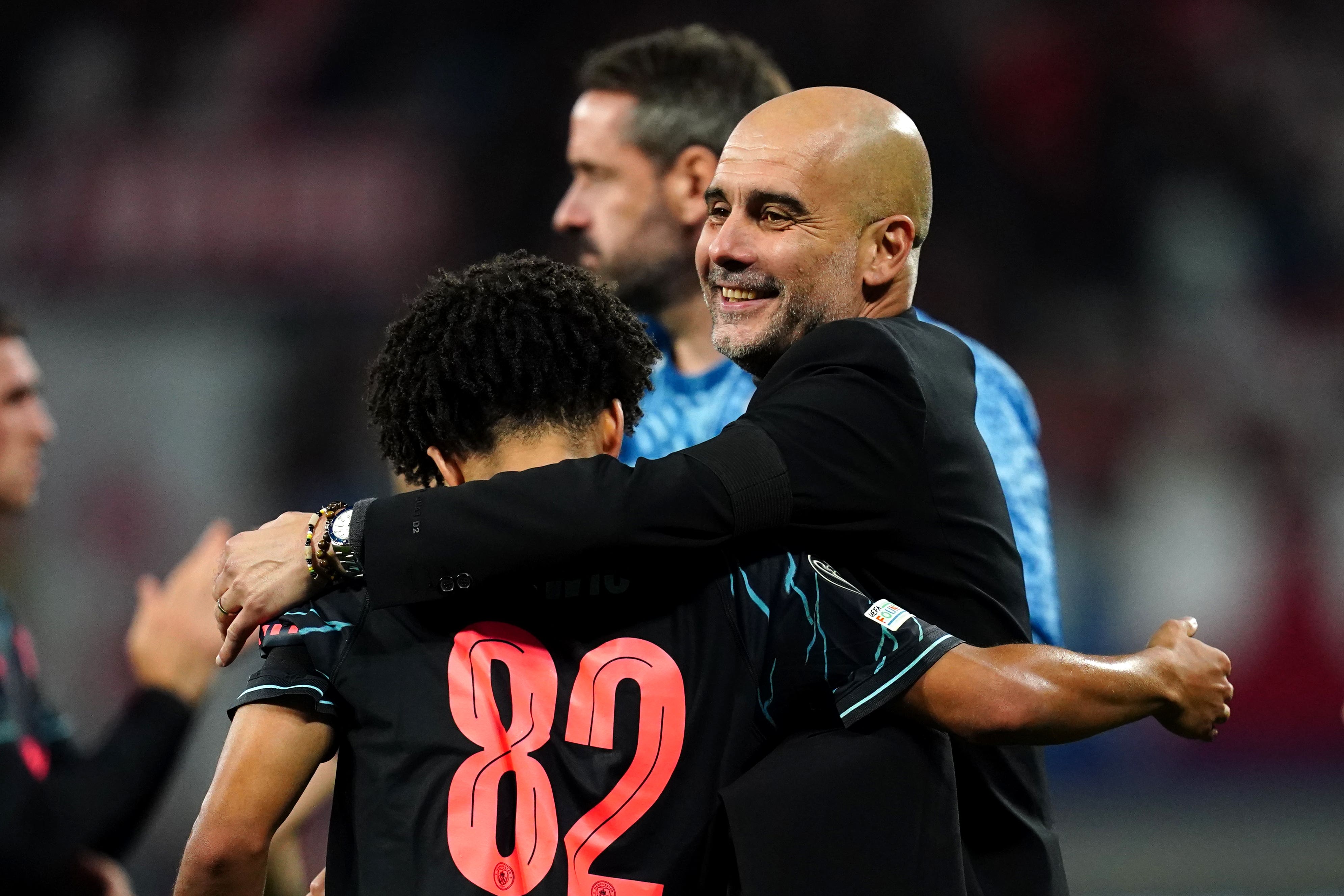 Pep Guardiola embraces Rico Lewis (Nick Potts/PA)