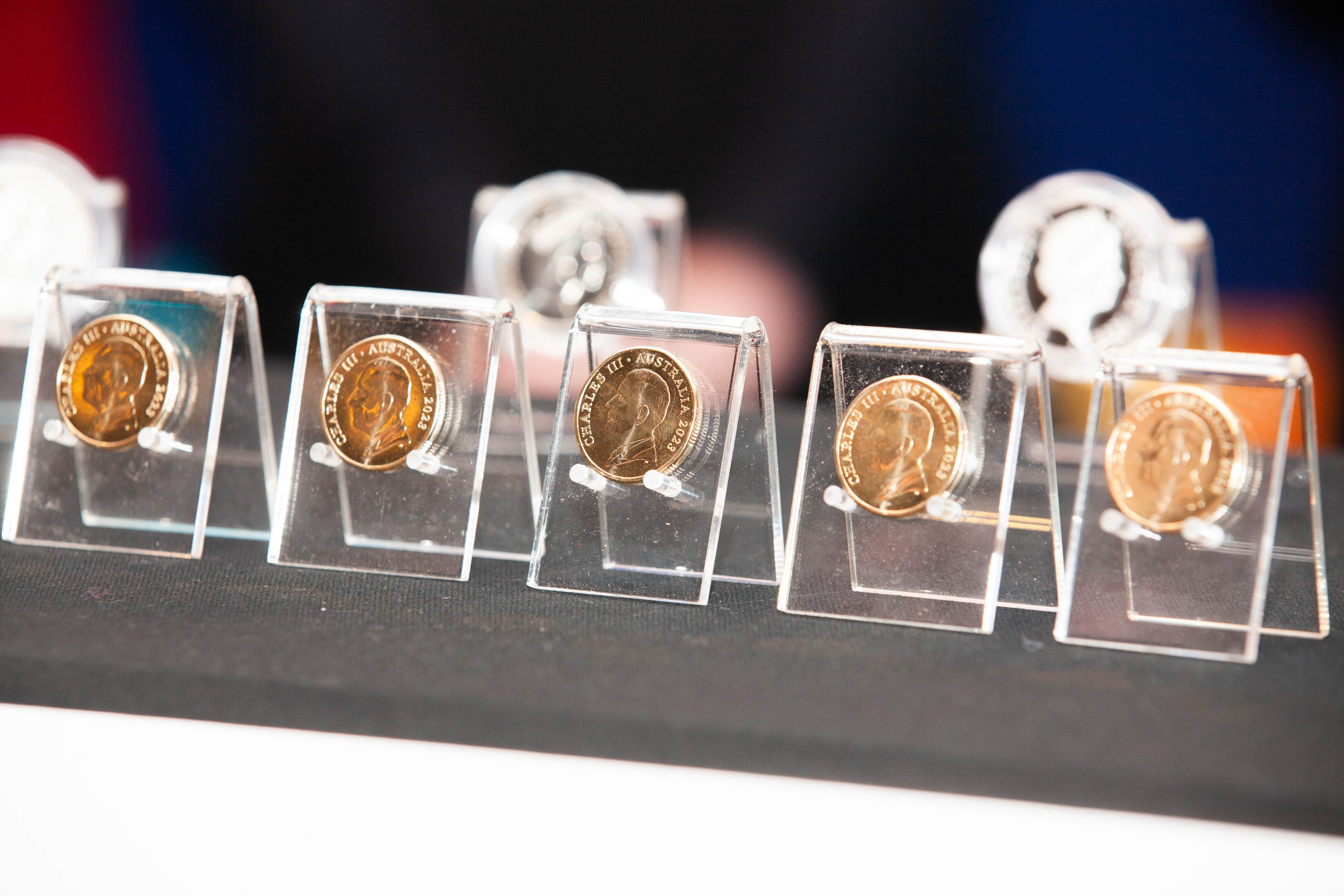 A number of dollar coins featuring the effigy of The King in Australia