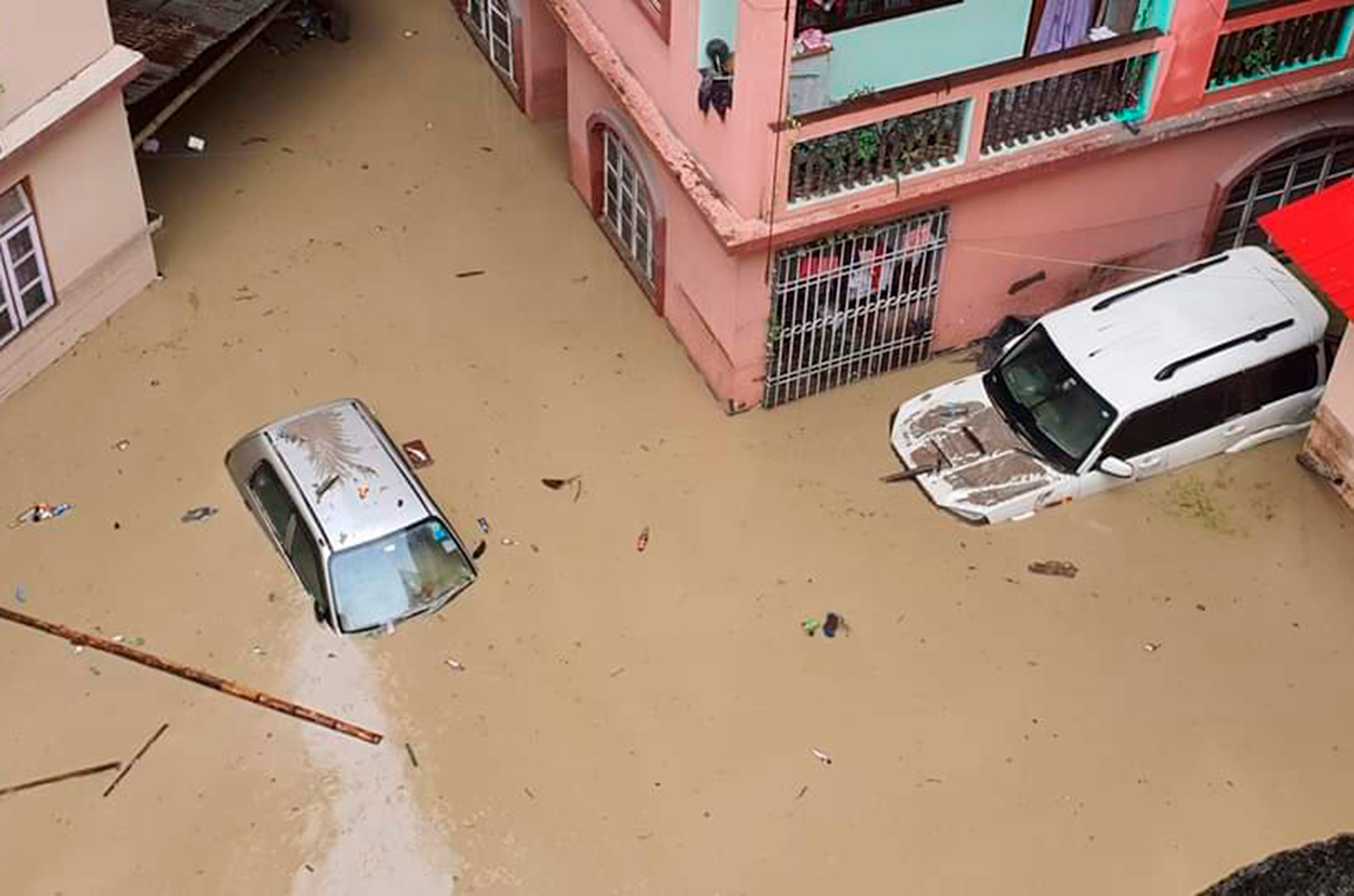 Cars lie submerged in water after flash floods triggered by a sudden heavy rainfall swamped the Rangpo town in Sikkim, India