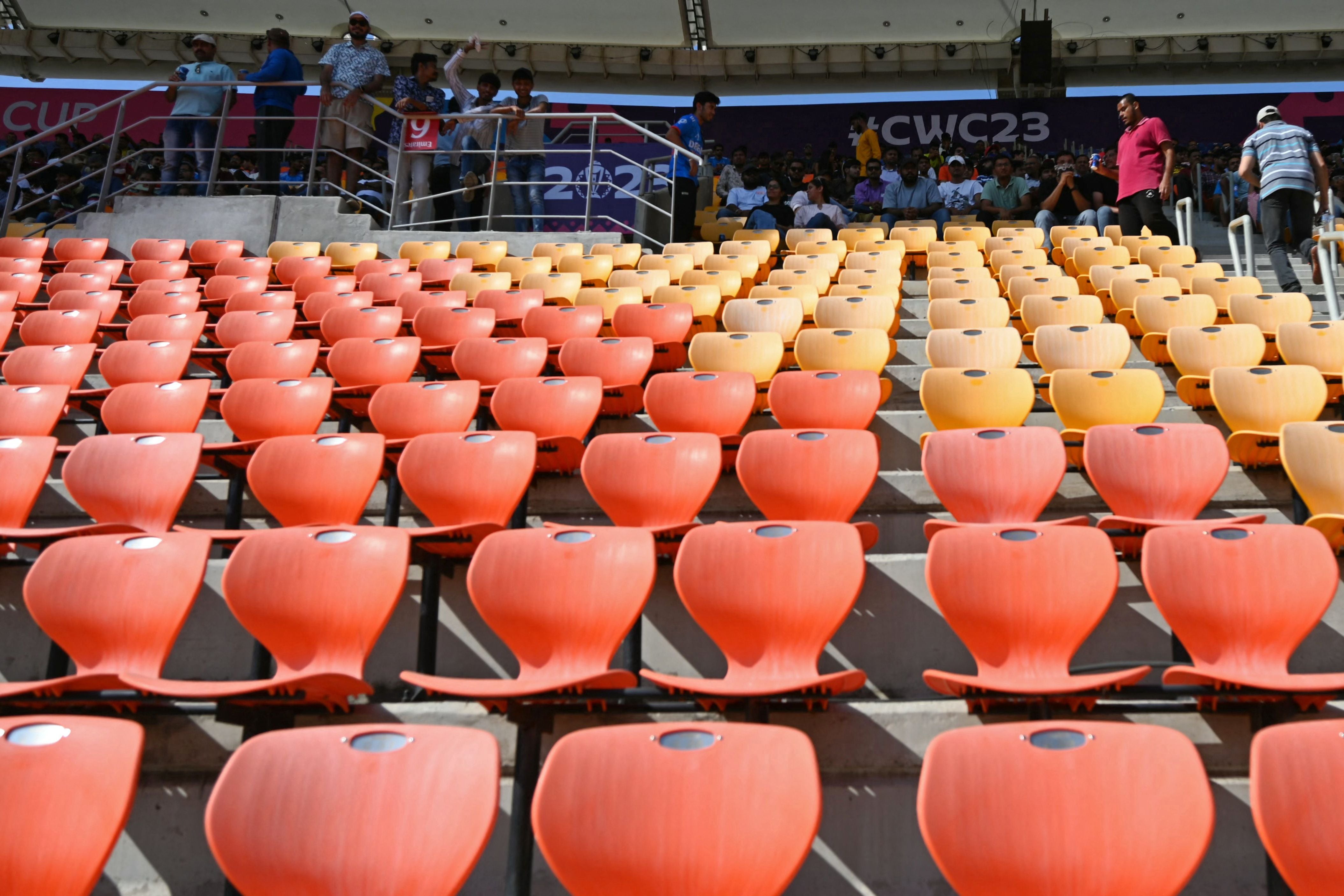 Spectators watch the 2023 ICC men's cricket World Cup one-day international (ODI) match between England and New Zealand at the Narendra Modi Stadium in Ahmedabad on 5 October 2023