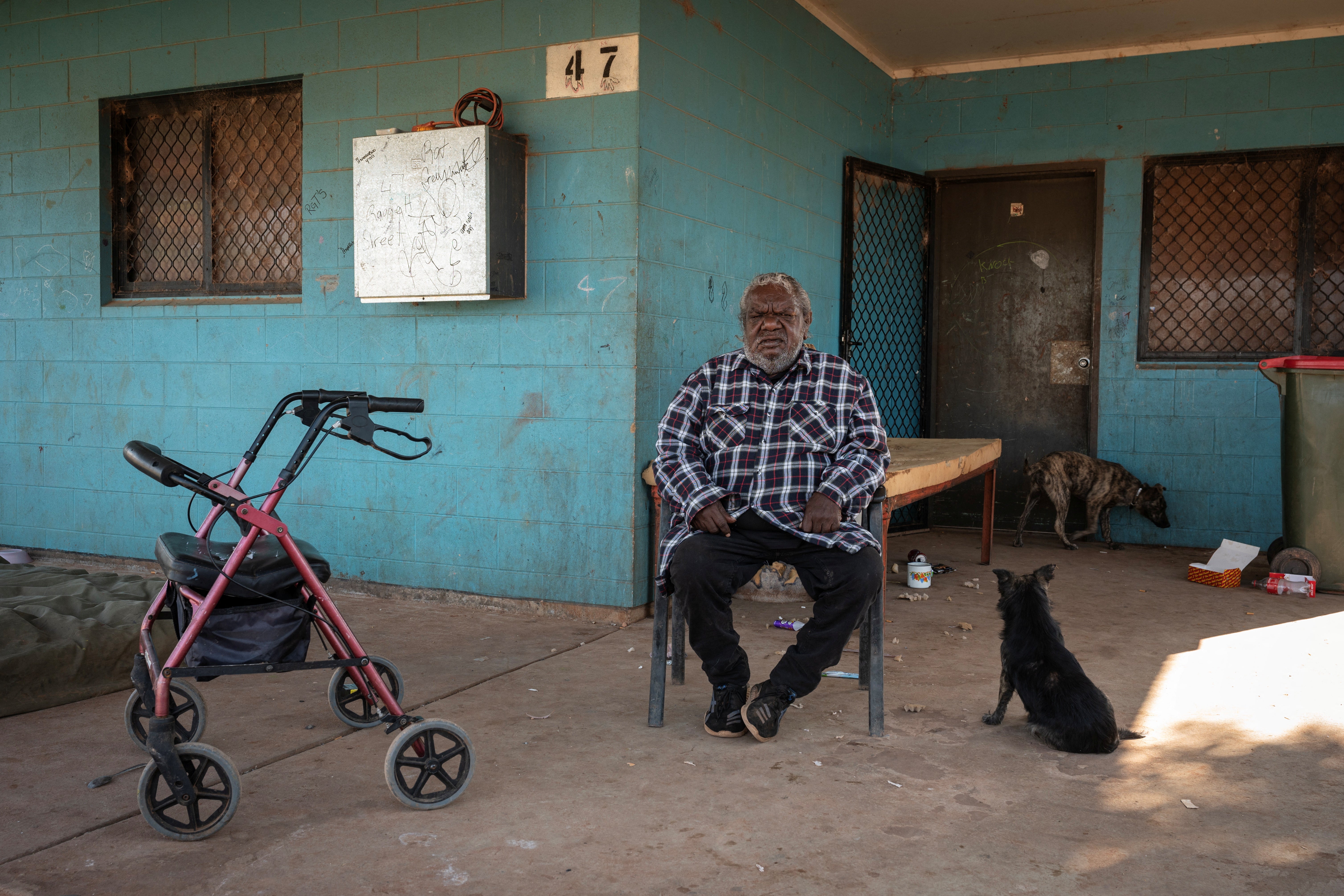 Retiree Patrick Oliver, 70, poses for a photo on the front porch of his home in Hermannsburg