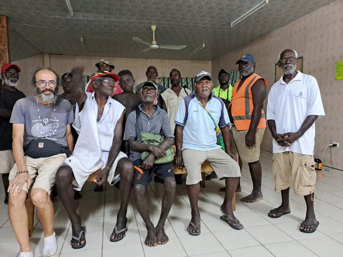 Gianluca Grimalda with residents in Papua New Guinea. He says his promise to locals about cutting his carbon footprint has given him resolve