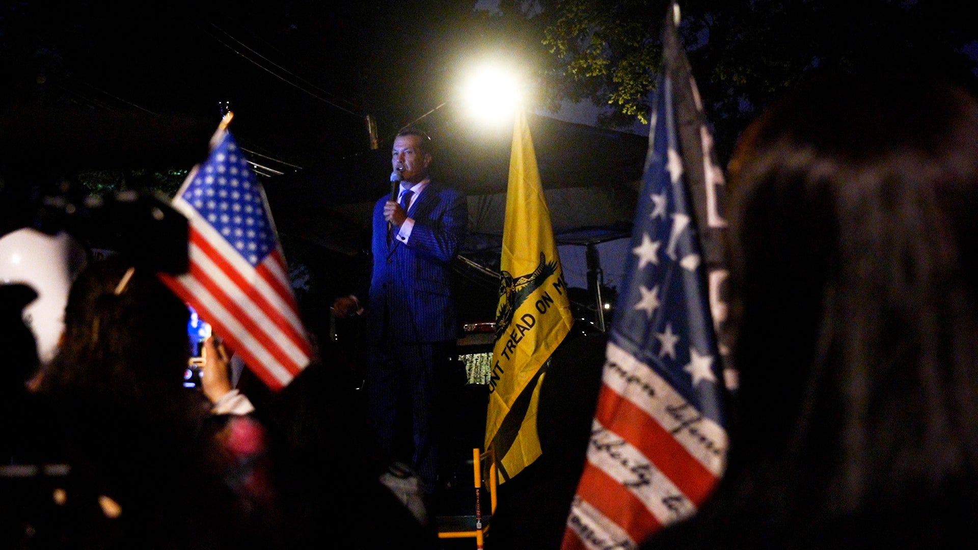 Right-wing TV personality Johnny Tabacco speaks to a crowd of protesters outside of a migrant centre in Staten Island.