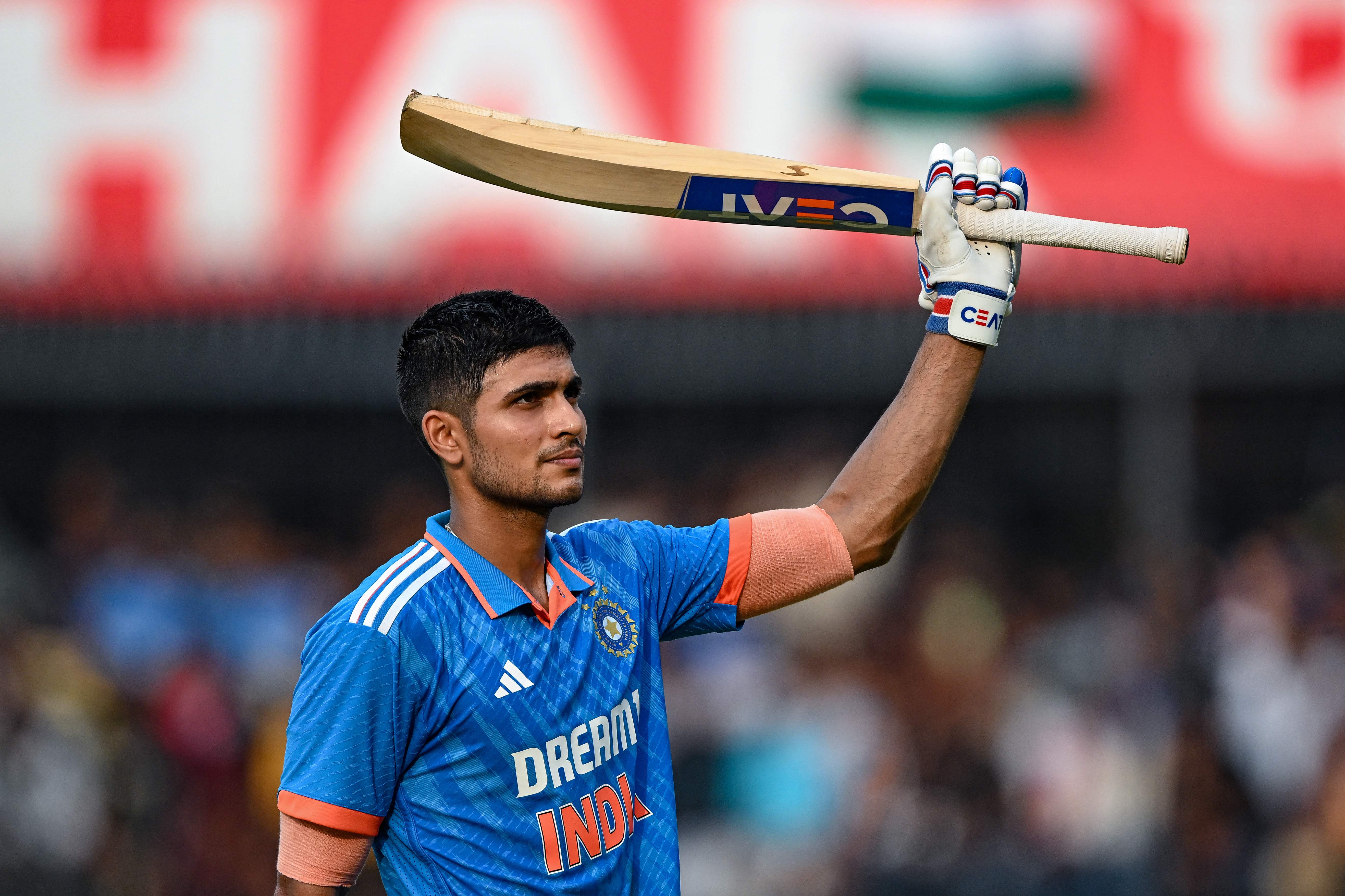 Shubman Gill celebrates after scoring a century (100 runs) during the second one-day international (ODI) cricket match between India and Australia at the Holkar Cricket Stadium in Indore on 24 September