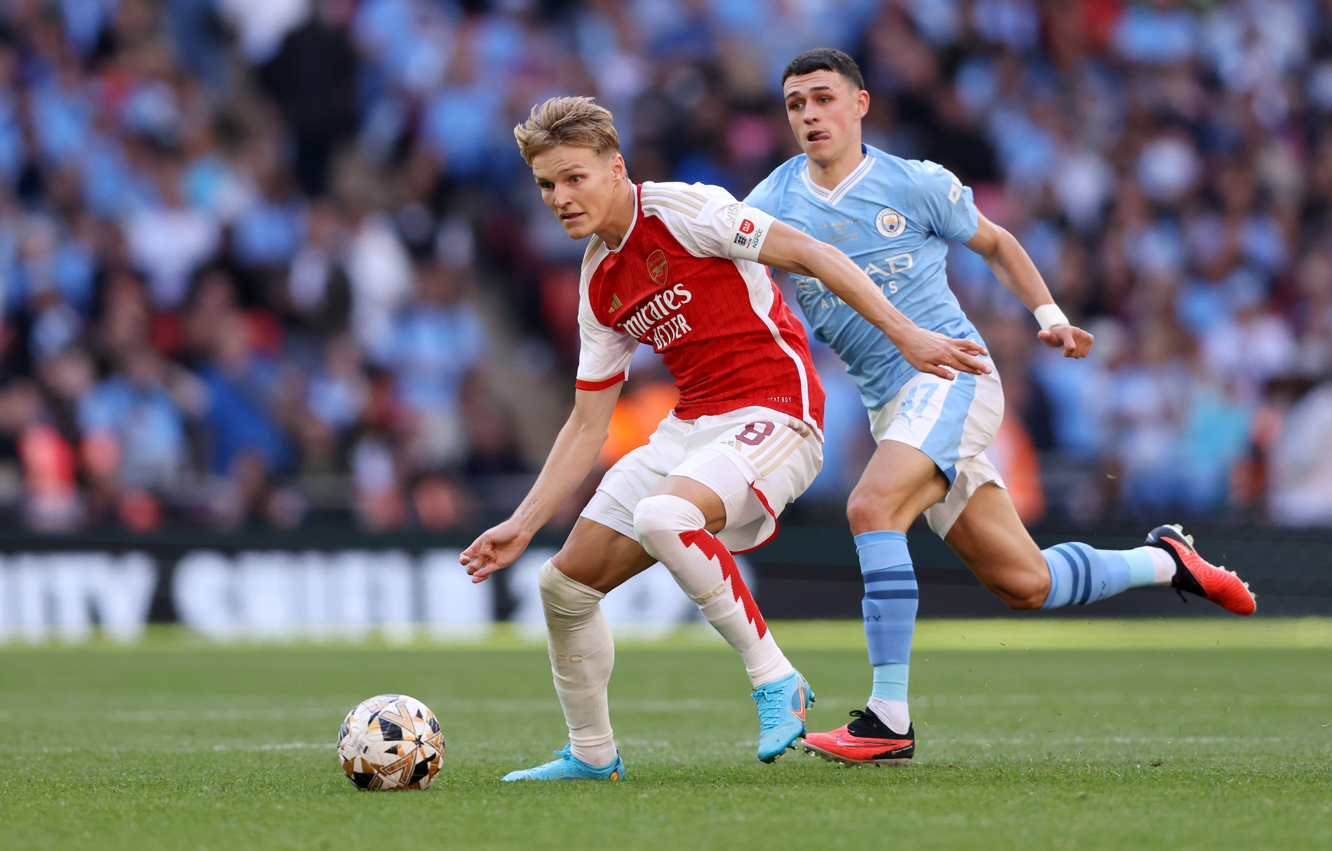 Martin Odegaard of Arsenal and Phil Foden of Manchester City battle for the ball during The FA Community Shield match in August