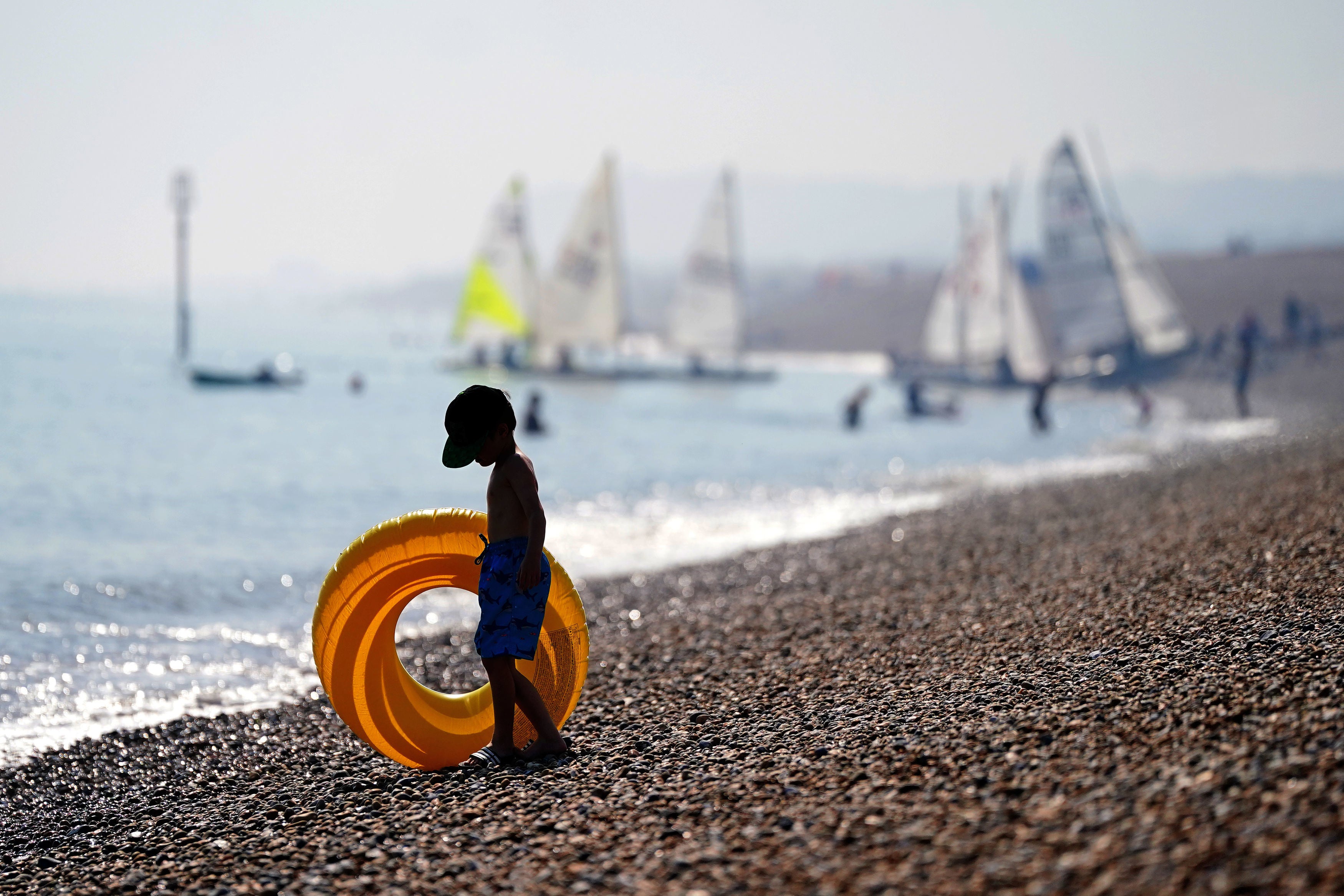 A child enjoys the autumn sun at a beach in Deal, Kent