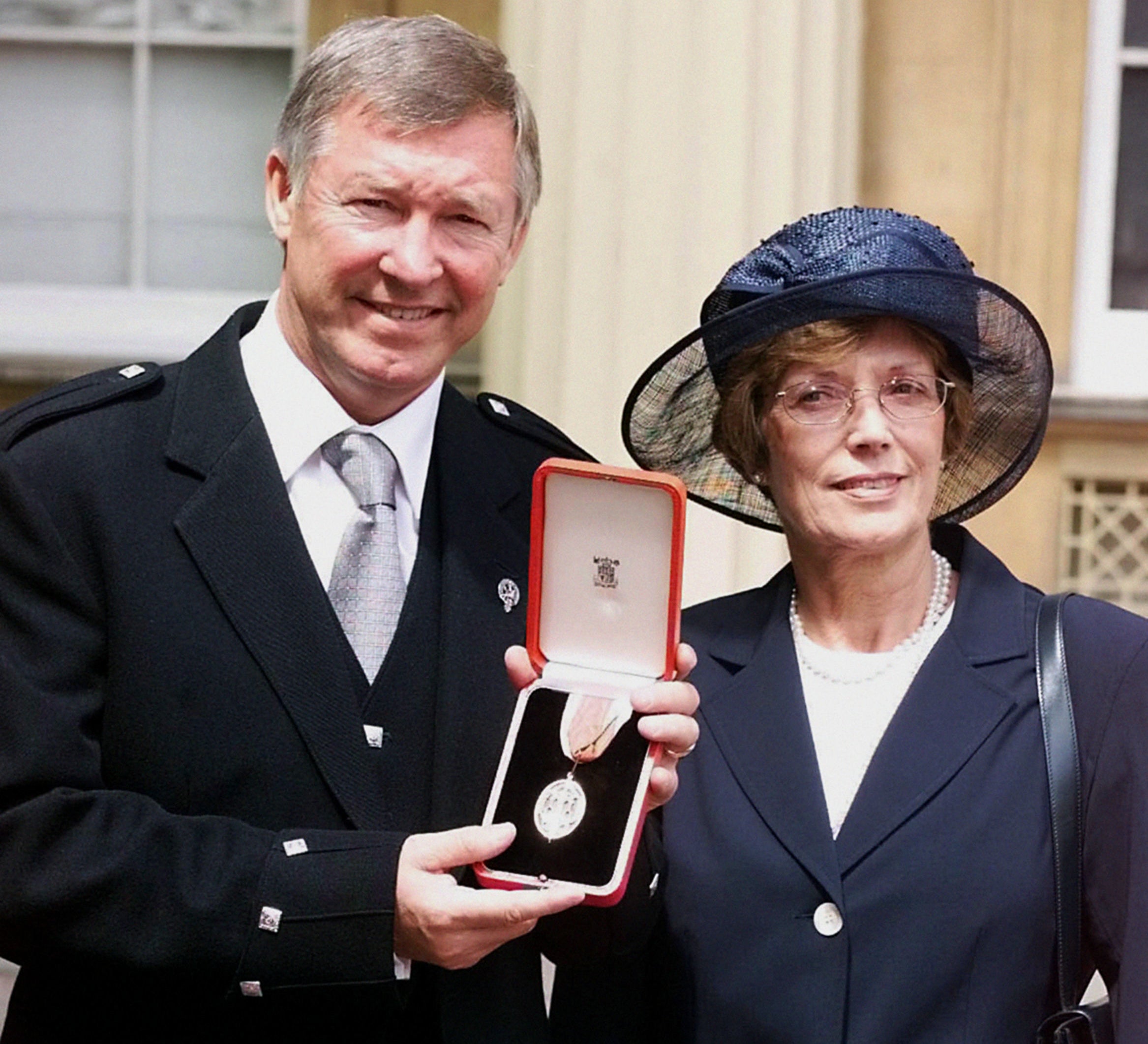 Sir Alex Ferguson receives his knighthood with Cathy in 1999