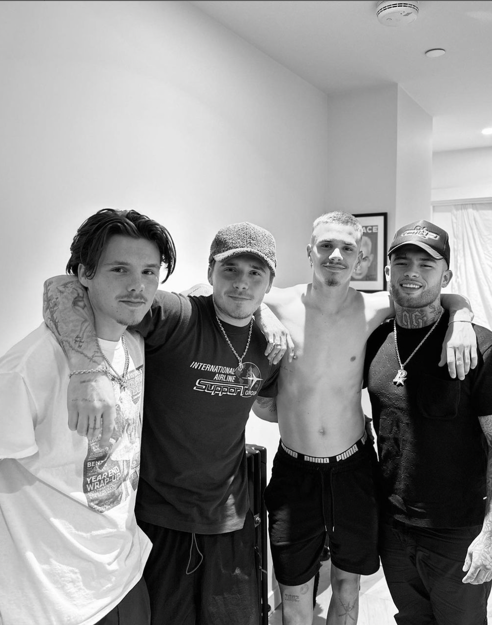 The Beckham brothers posing with their tattoo artist