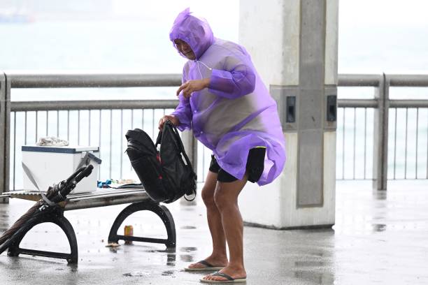 A man struggles with strong winds as Hong Kong hoisted typhoon signal no 8