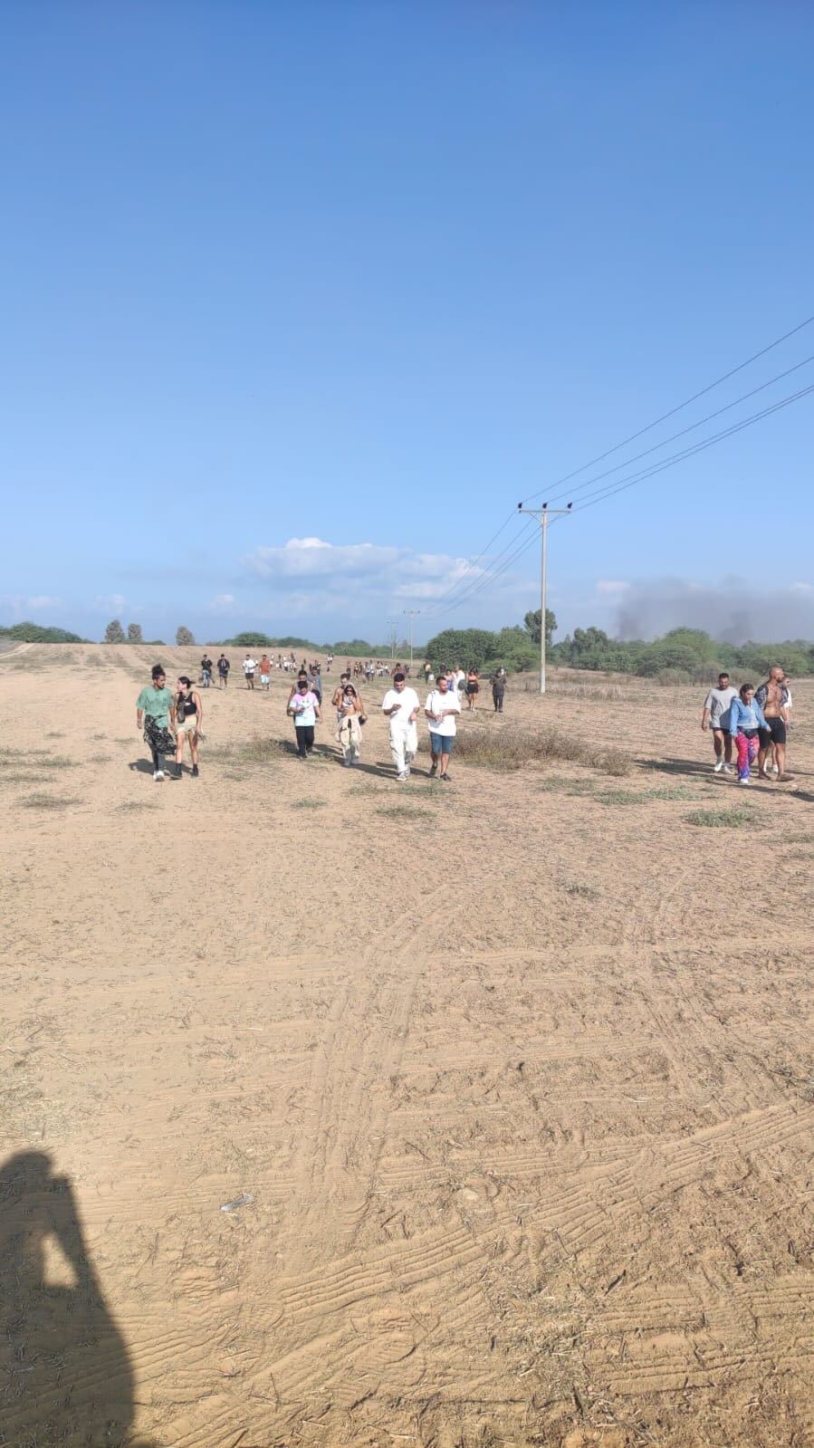 Partygoers run from the rave in the Israeli desert after it was hit by bombing