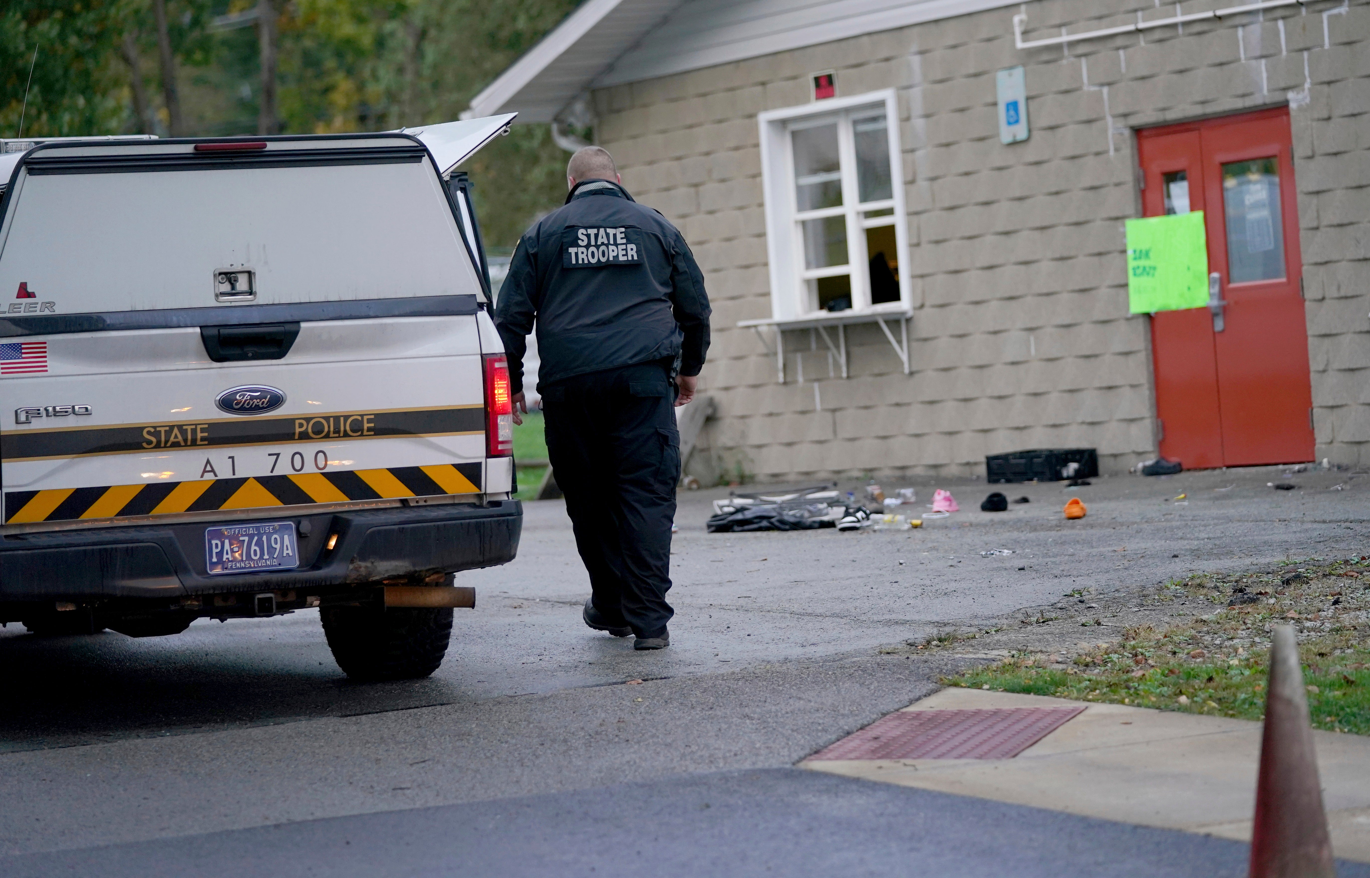 FILE: A trooper from the Pennsylvania State Police Reconstruction Unit works at the crime scene of a fatal shooting at the Chevy Chase Community Center. An Indian student died days after being stabbed in the head while working out at a fitness centre near his university in Indiana