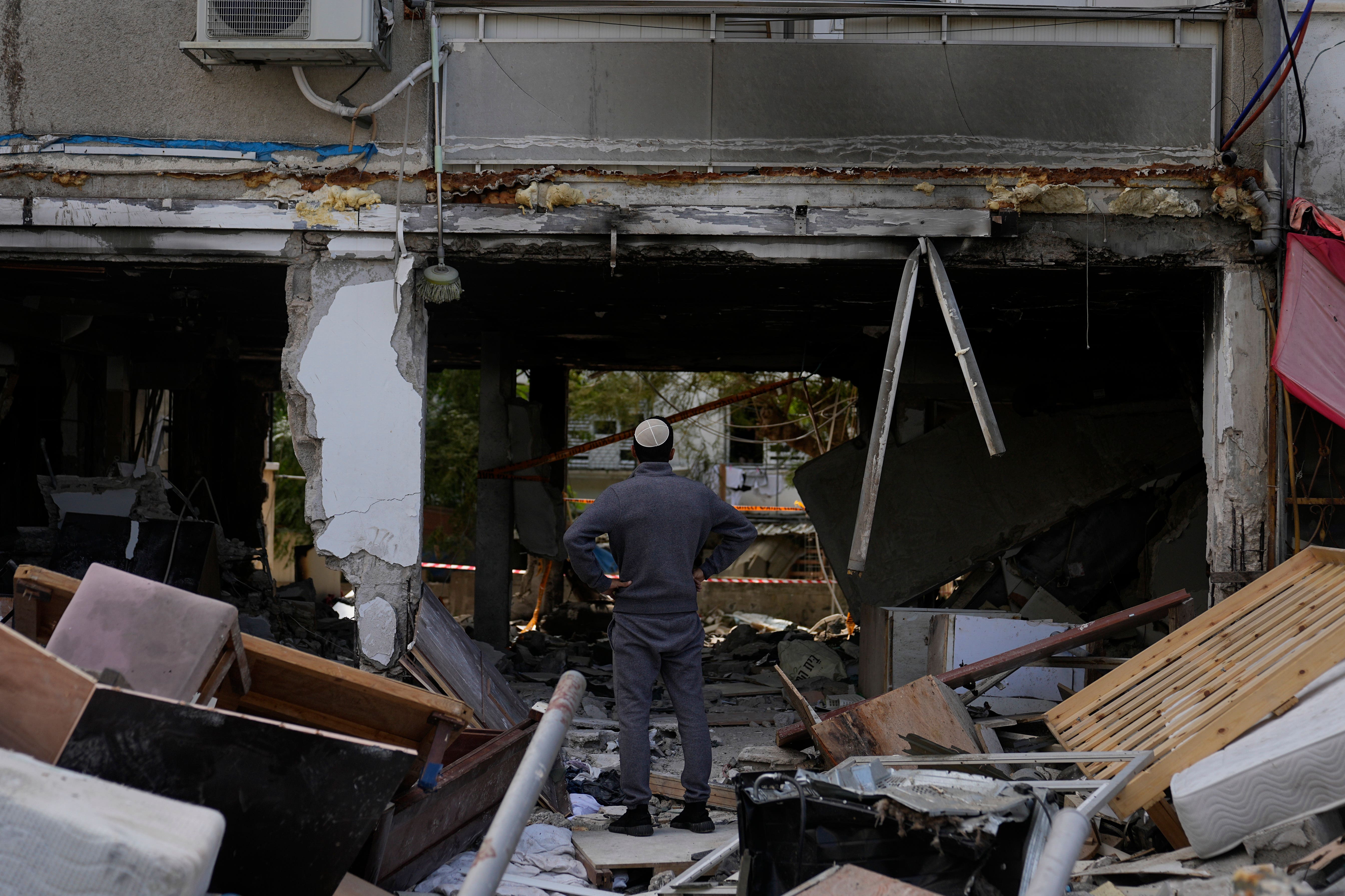 A man looks at destruction made by a rocket fired from the Gaza Strip in Ashkelon, Israel (Ohad Zwigenberg/AP/PA)