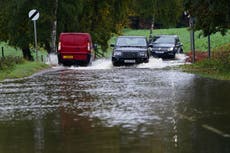 Police use drones to search for missing man swept into river after extreme rain