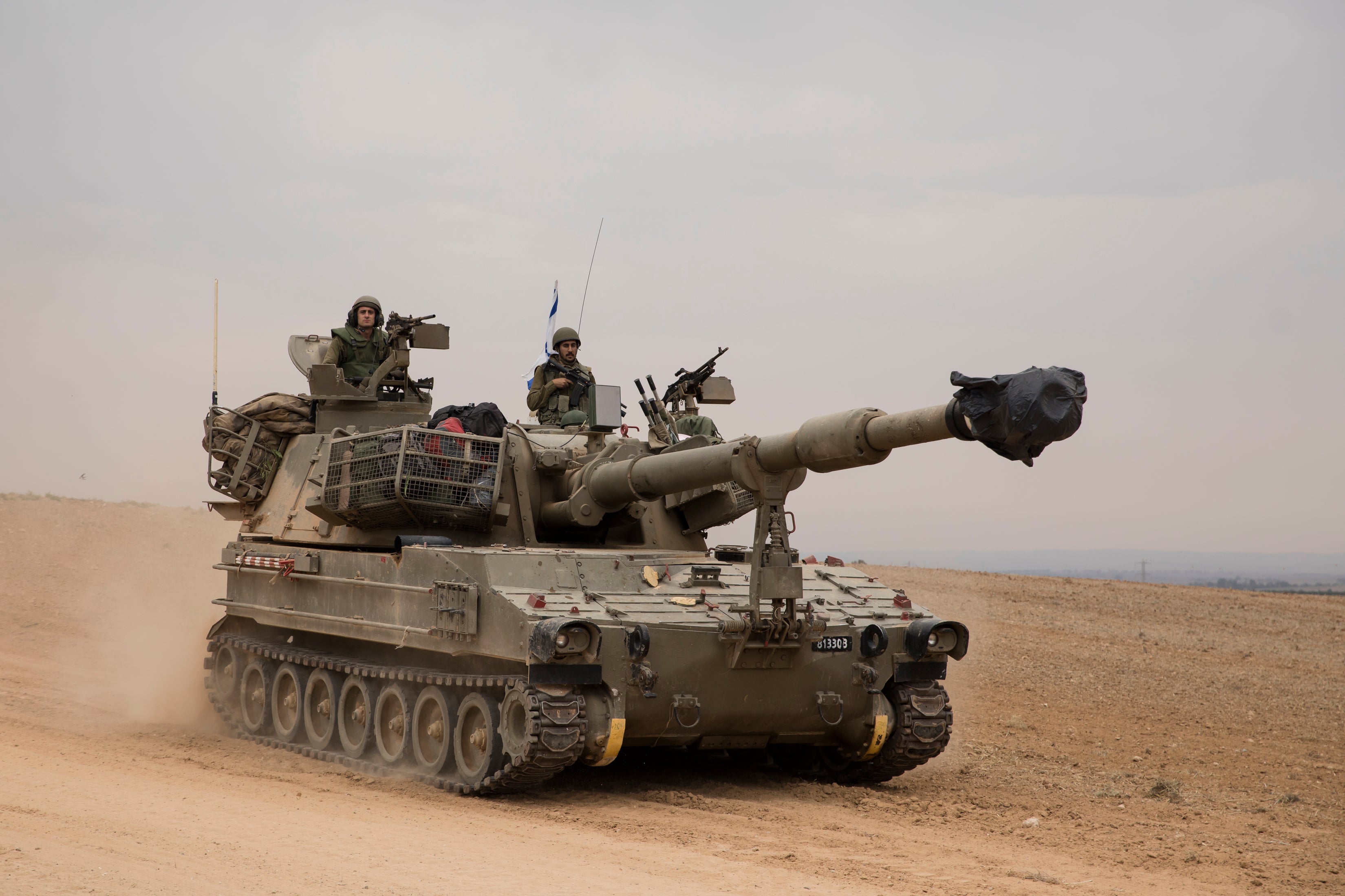 An Israeli tank drives toward the southern border with the Gaza Strip