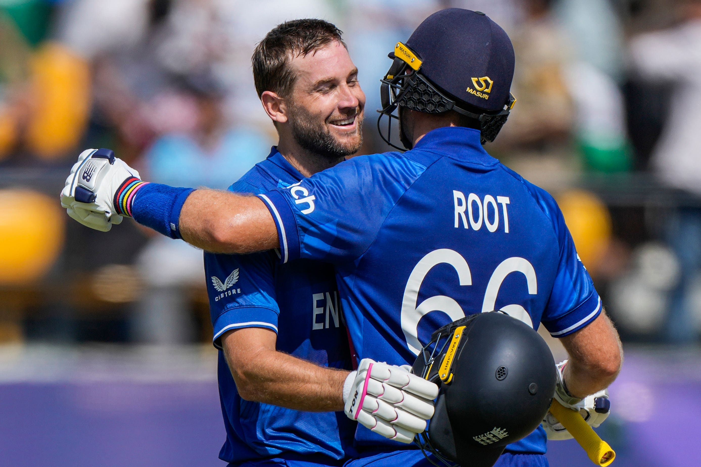 Dawid Malan, left, celebrates his century with Joe Root (Ashwini Bhatia/AP)