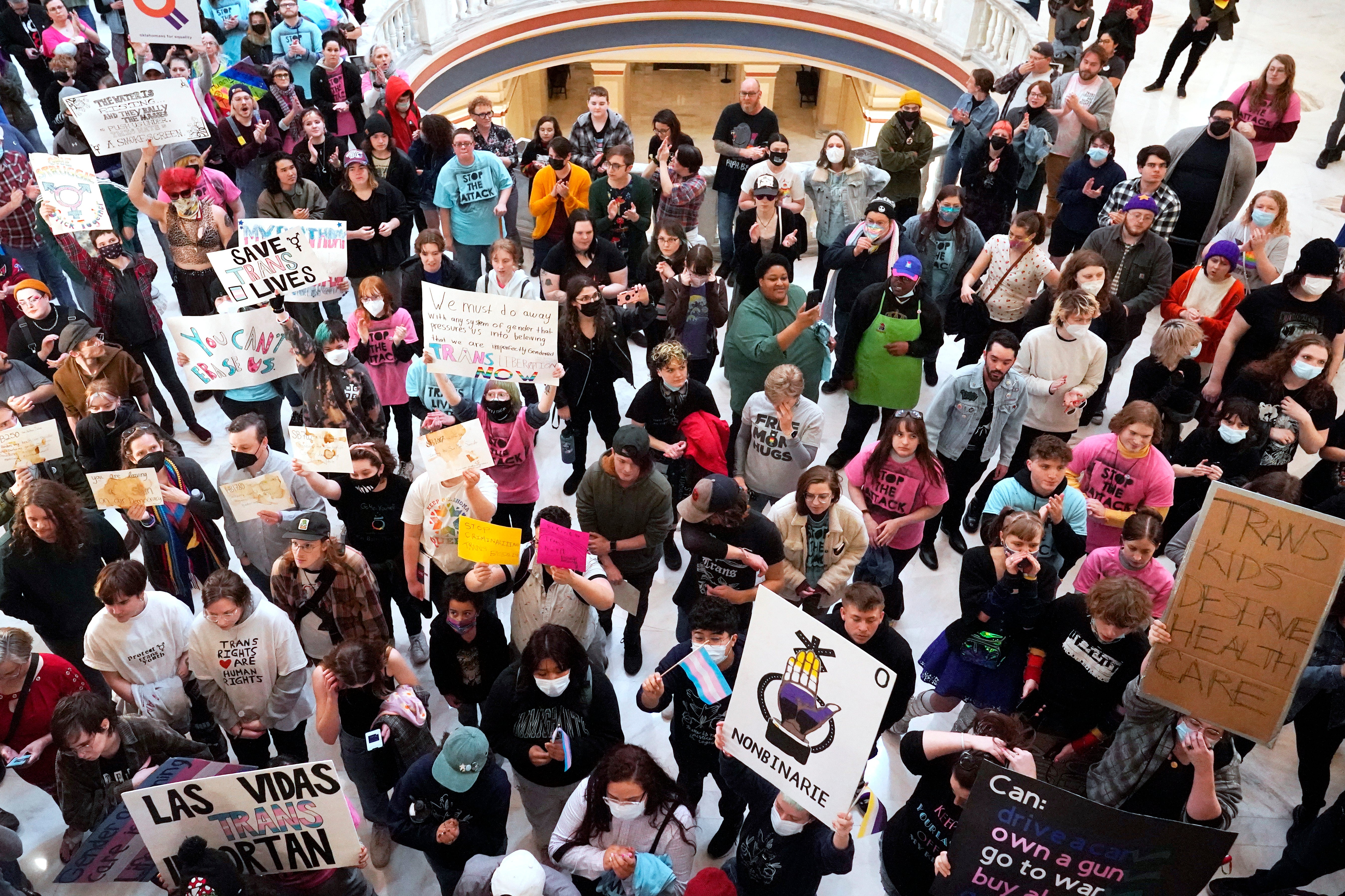 Trans-rights activists protest outside the House chamber at the Oklahoma state Capitol before the State of the State address in February 2023