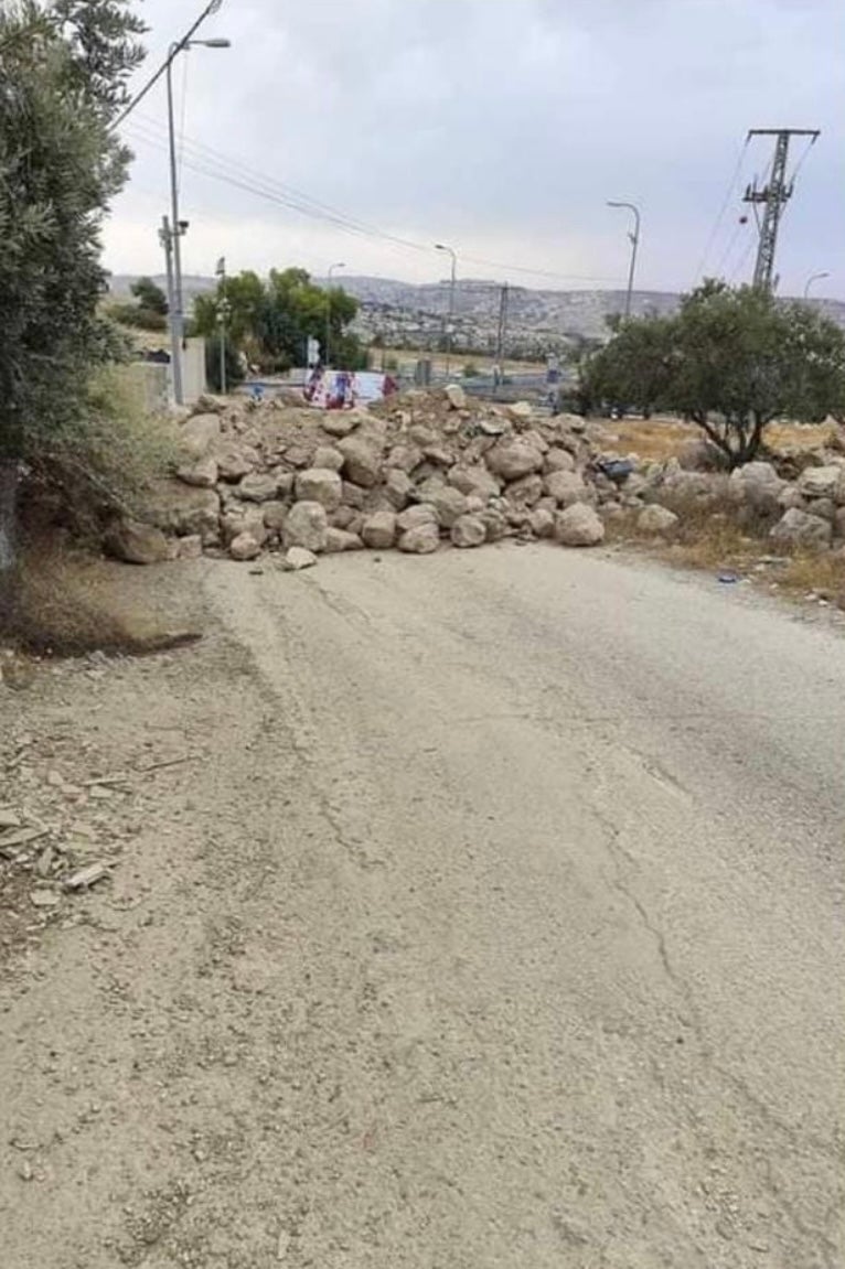 Rubble and concrete boulders block a road in Bayt Ta’mar, a village near Bethlehem