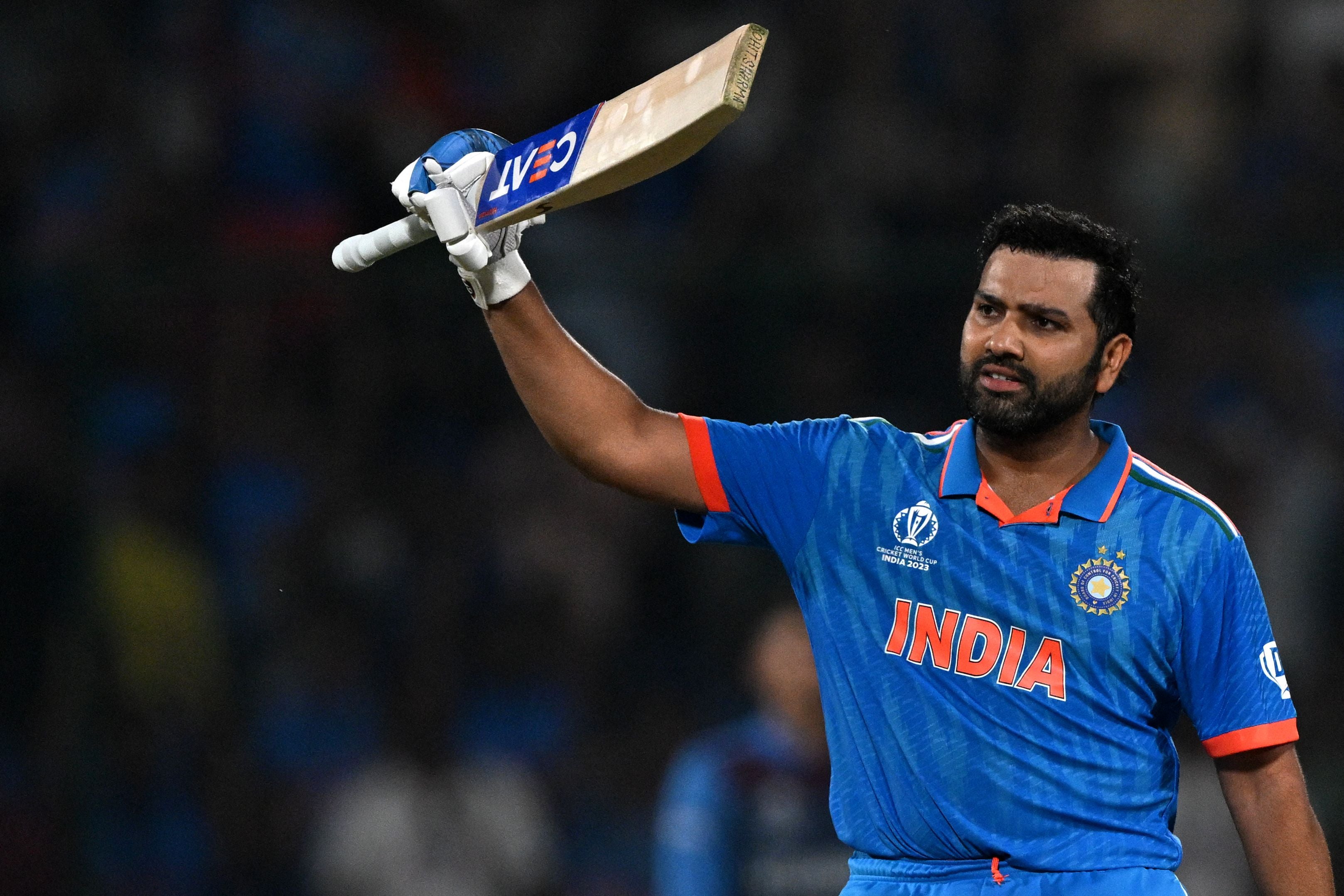 India’s captain Rohit Sharma celebrates after scoring a century during the 2023 ICC Men’s Cricket World Cup one-day international (ODI) match between India and Afghanistan