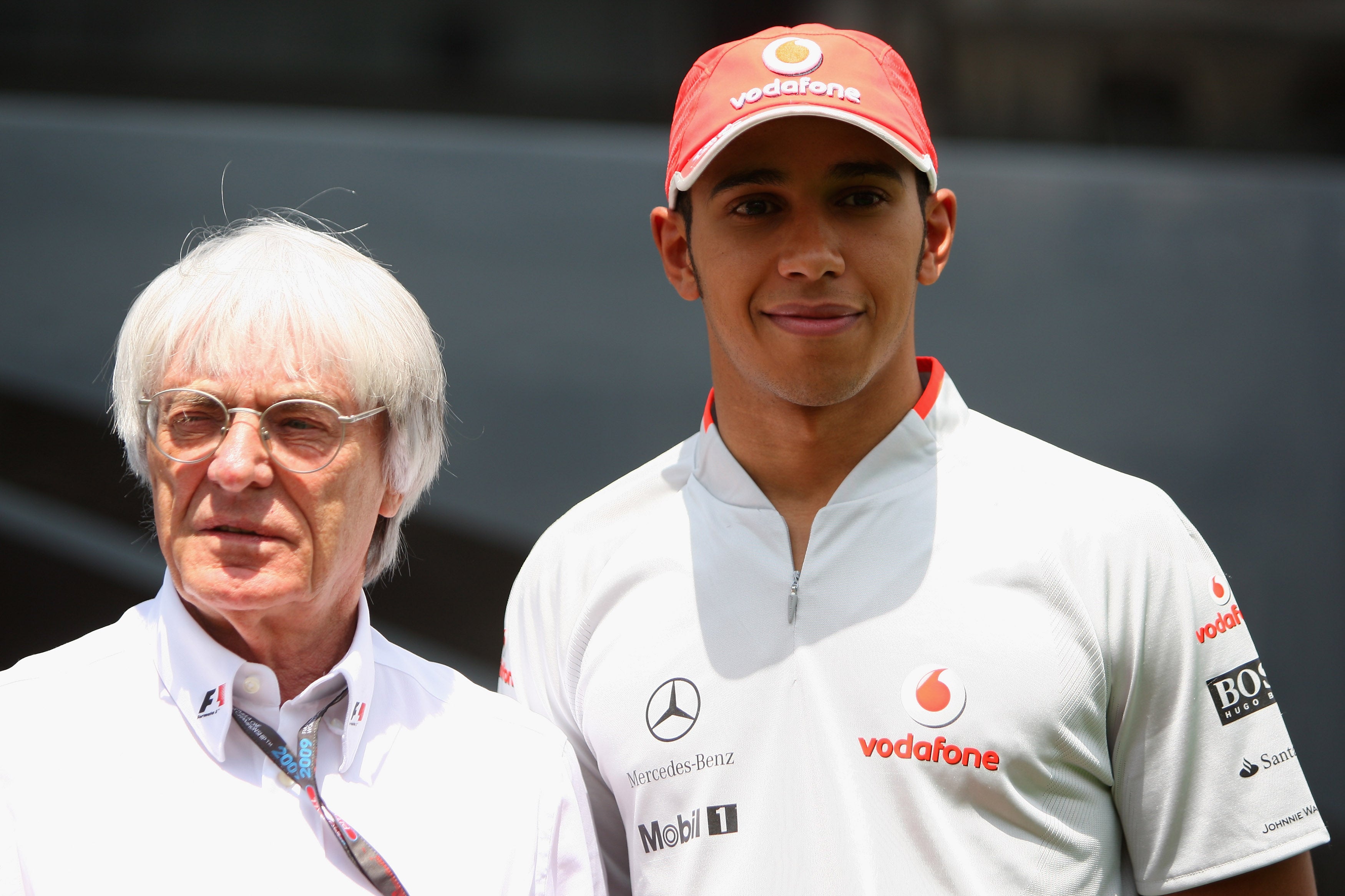 Ecclestone pictured with seven-time F1 world champion Lewis Hamilton (right)