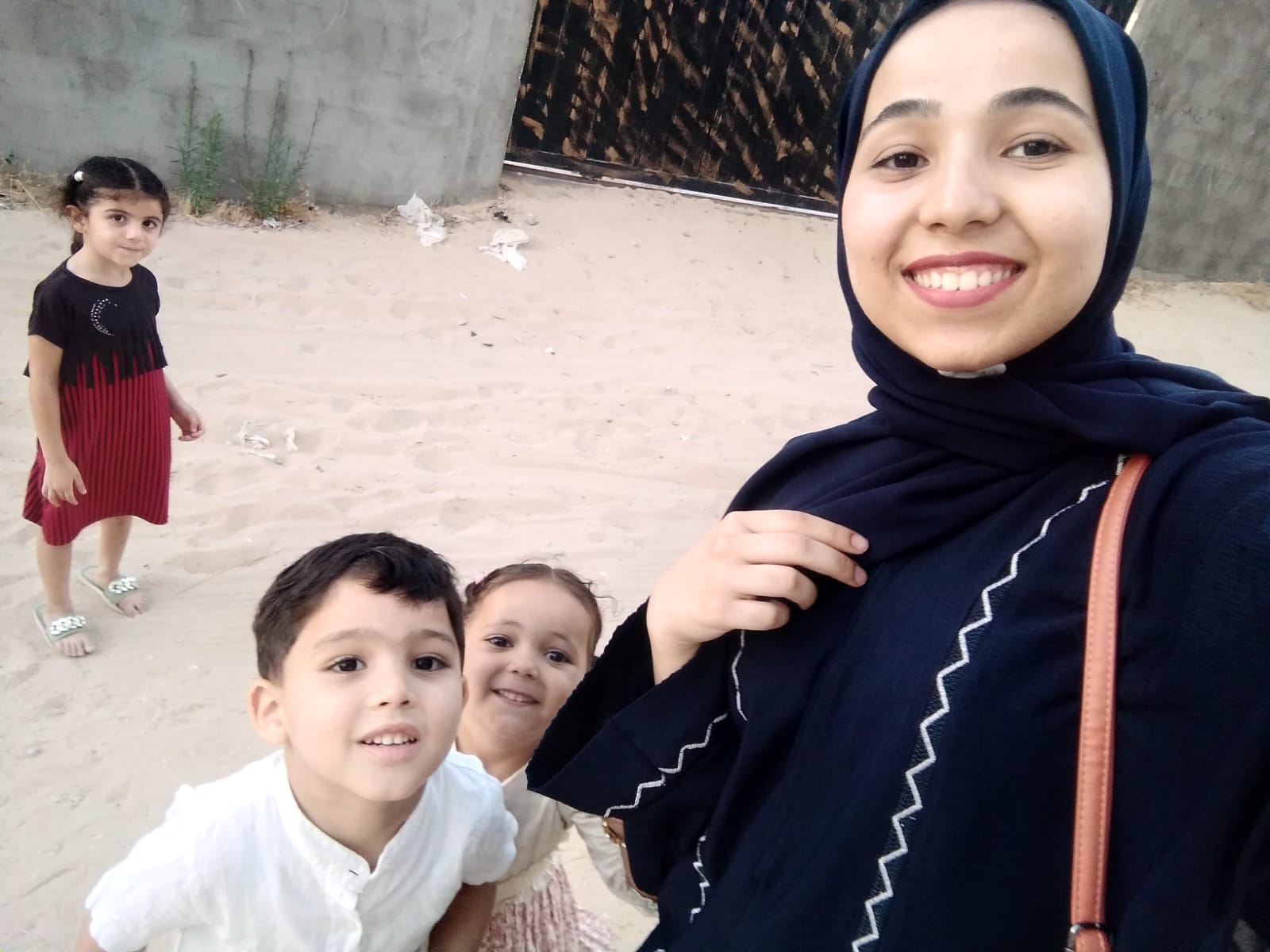 Dima Mohamed Abu Asaker with her nephews who ‘cannot endure the sounds of the bombs’