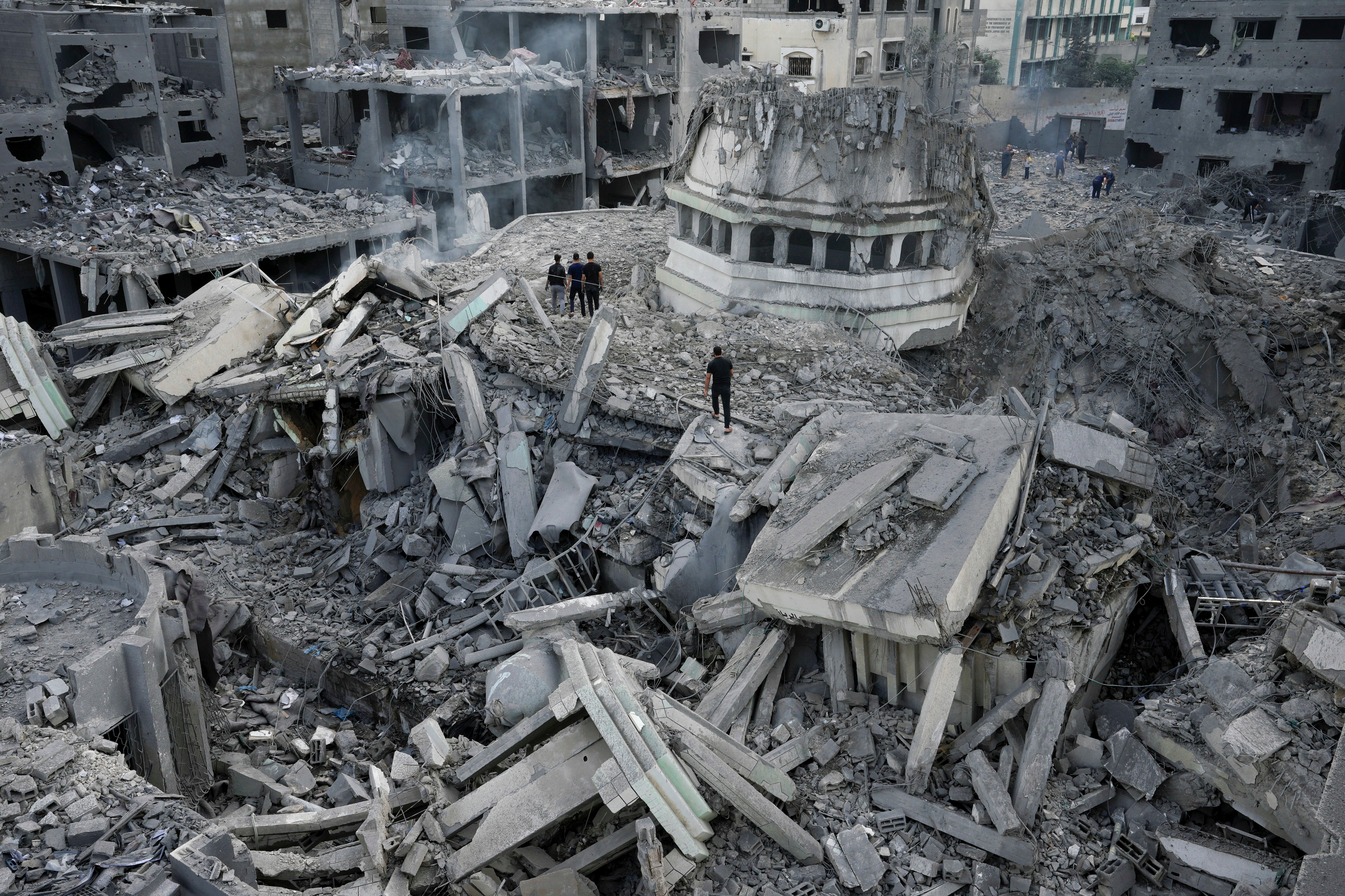 Palestinians inspect the rubble of the Yassin Mosque destroyed after it was hit by an Israeli airstrike at Shati refugee camp in Gaza City, early Monday, Oct. 9, 2023.