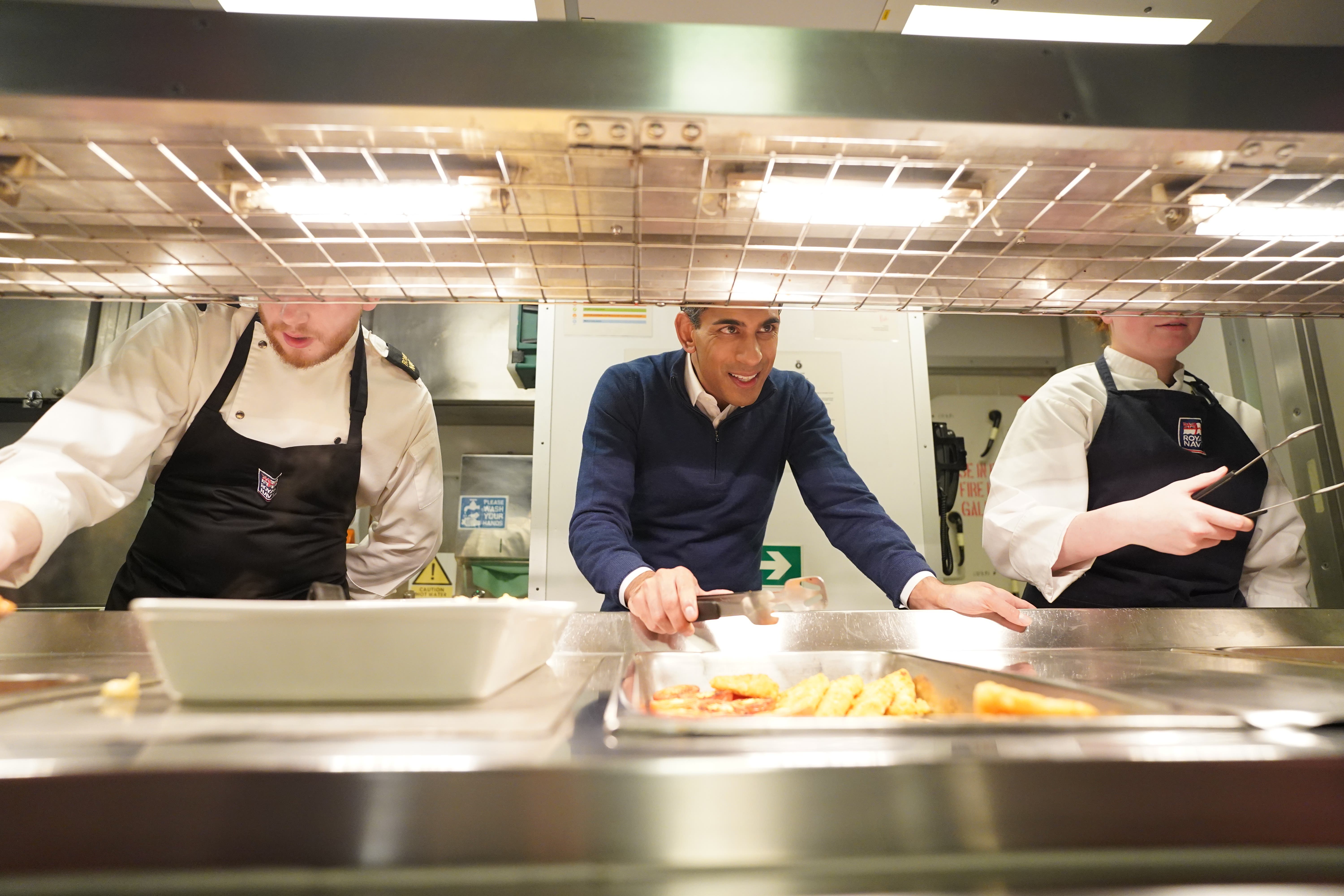 Prime Minister Rishi Sunak serving breakfast to the crew on board HMS Diamond (Stefan Rousseau/PA)