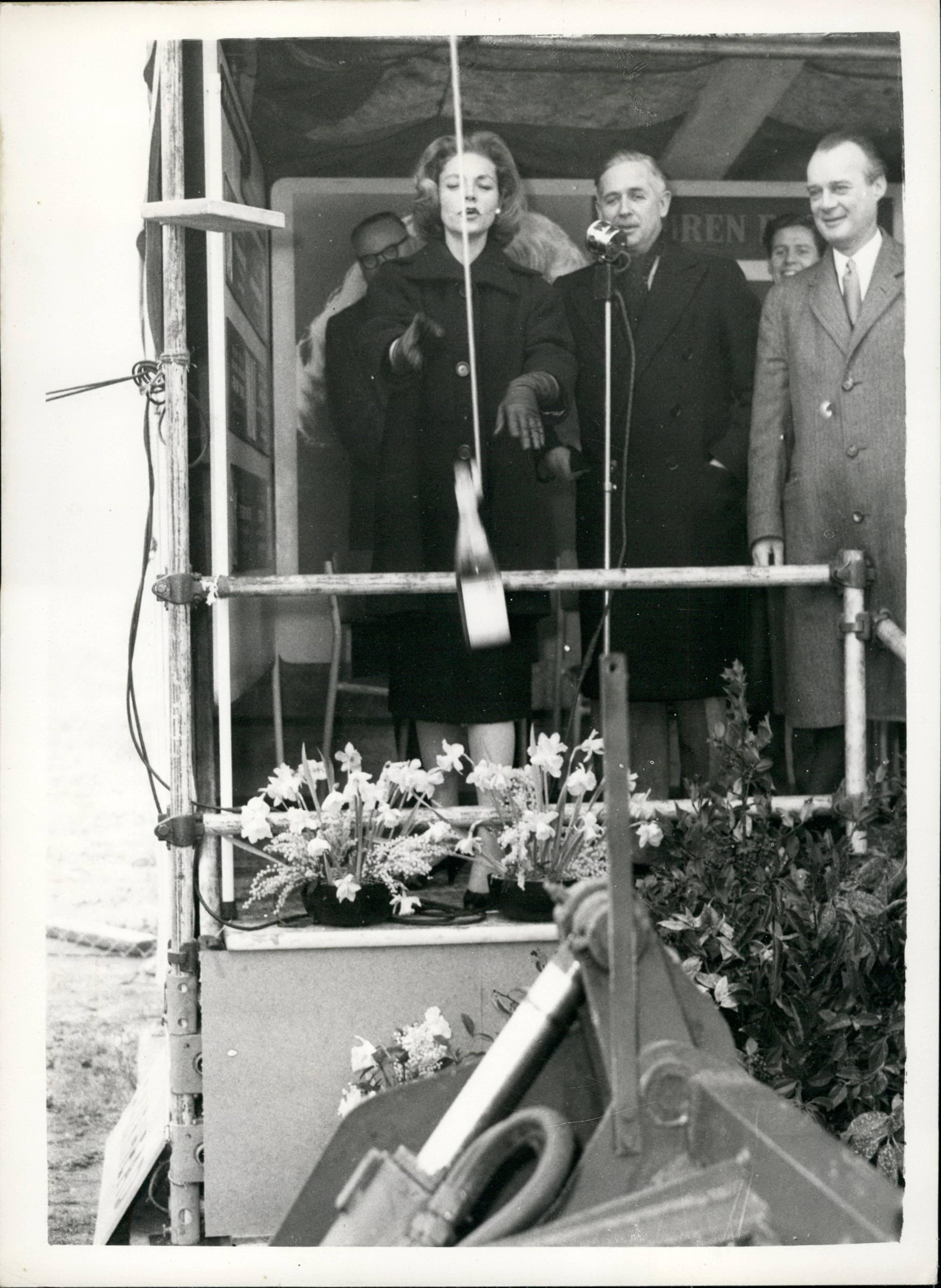 Lauren Bacall breaks a bottle of champagne over a bulldozer, in a ceremony to mark the start of work on the new Odeon cinema in Hemel Hempstead, January 1959