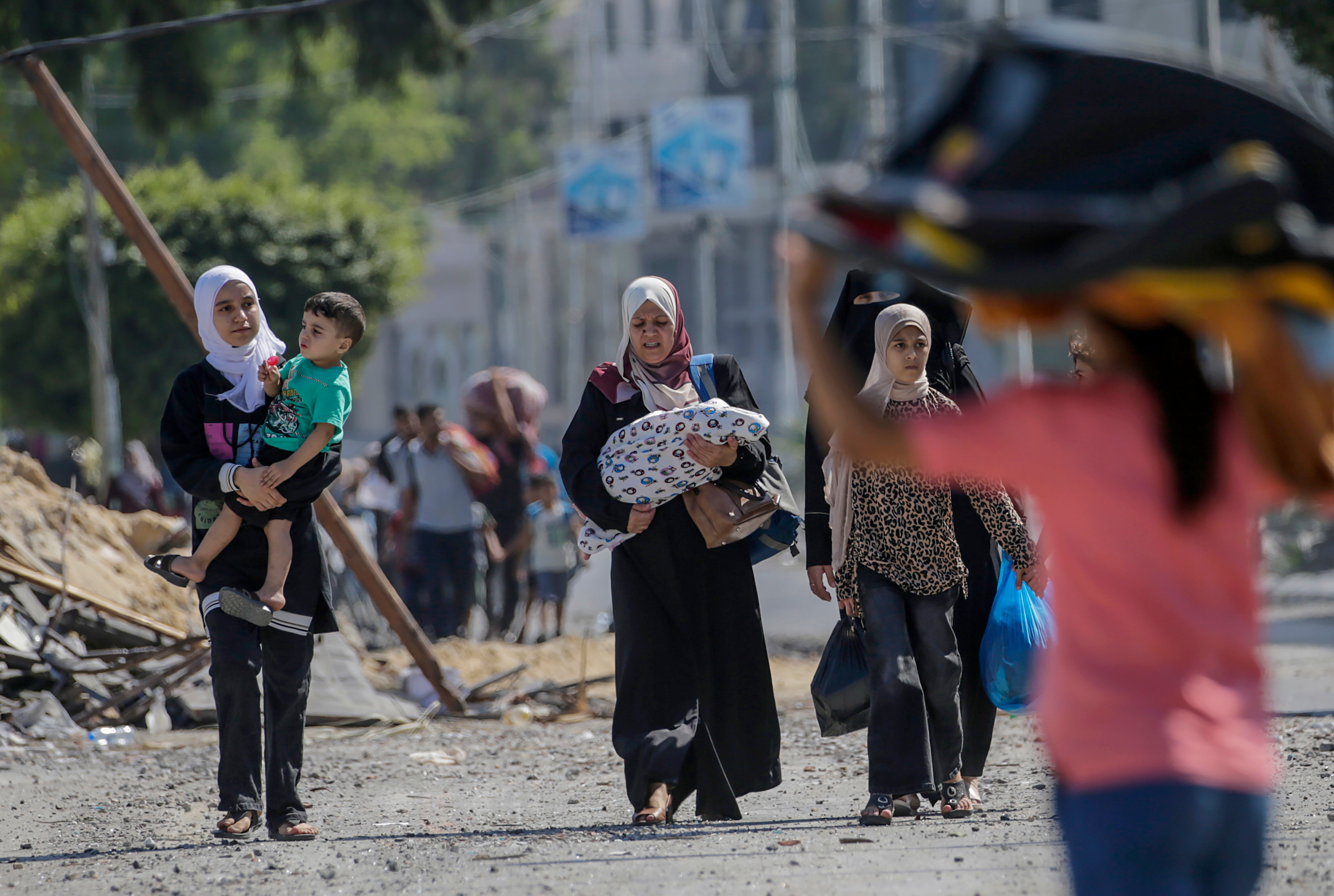 Women and children evacuate Gaza City following an Israeli warning of increased military operations