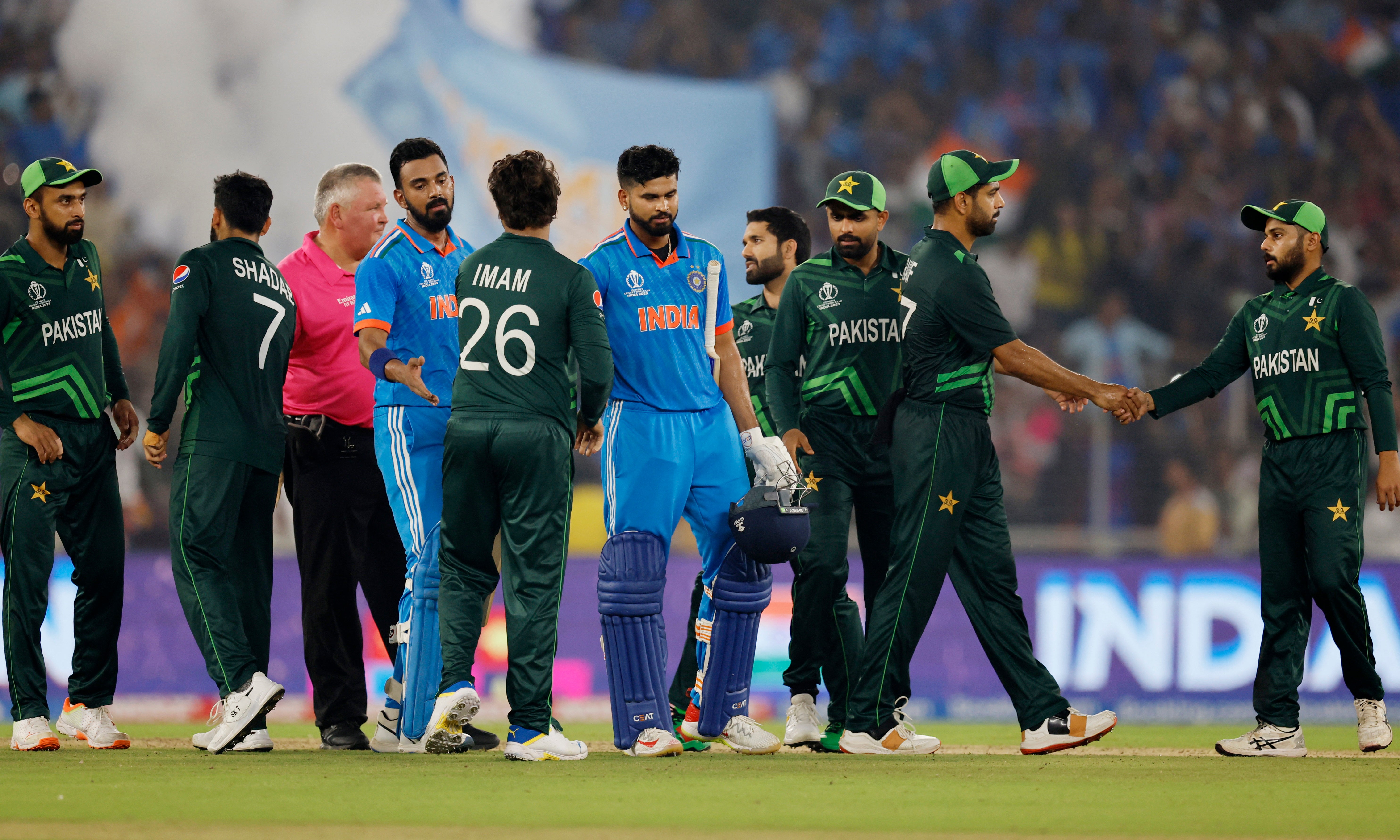 The teams shake hands at the end of the match