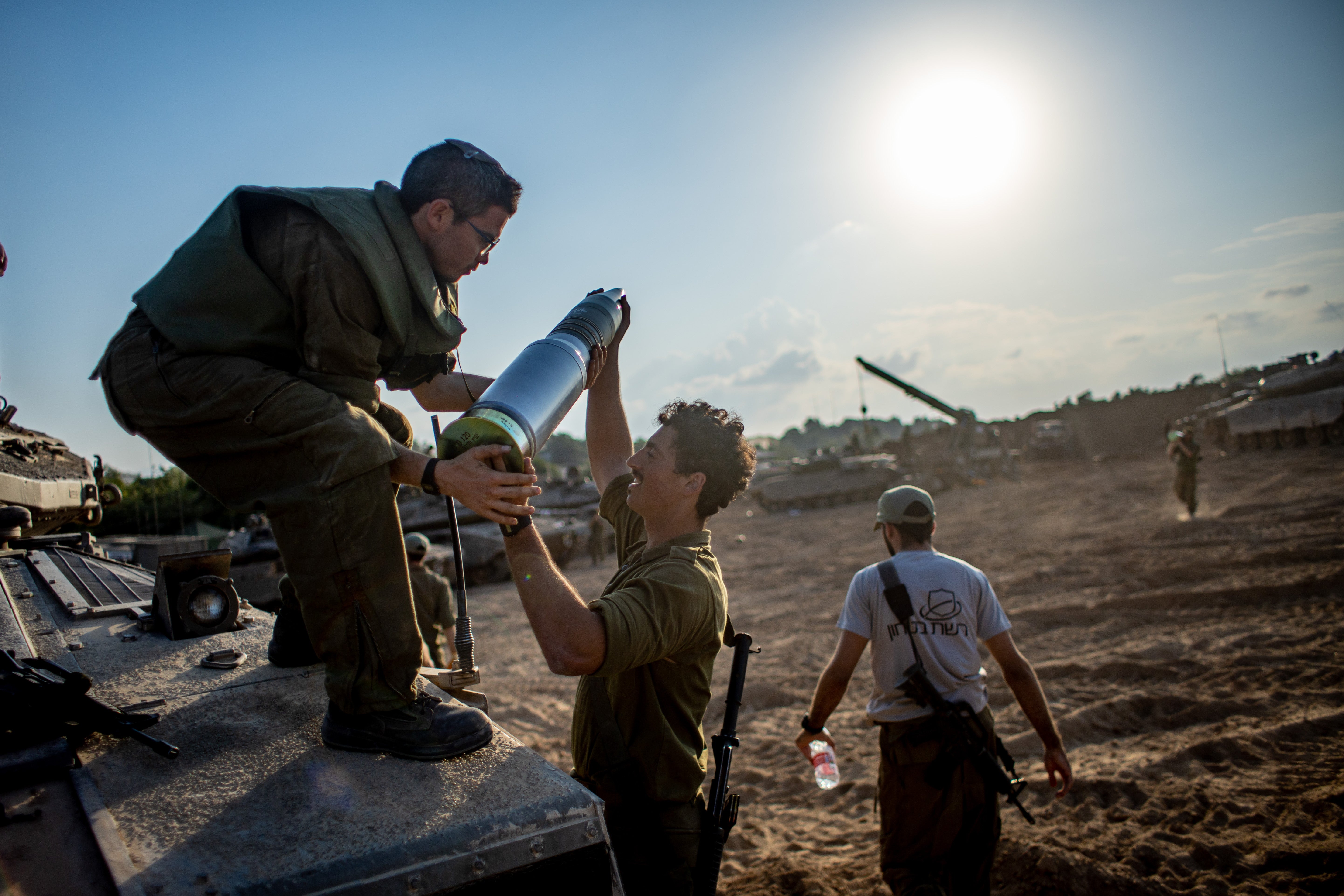 Israeli forces prepare at an undisclosed location along the border with Gaza in southern Israel on Saturday