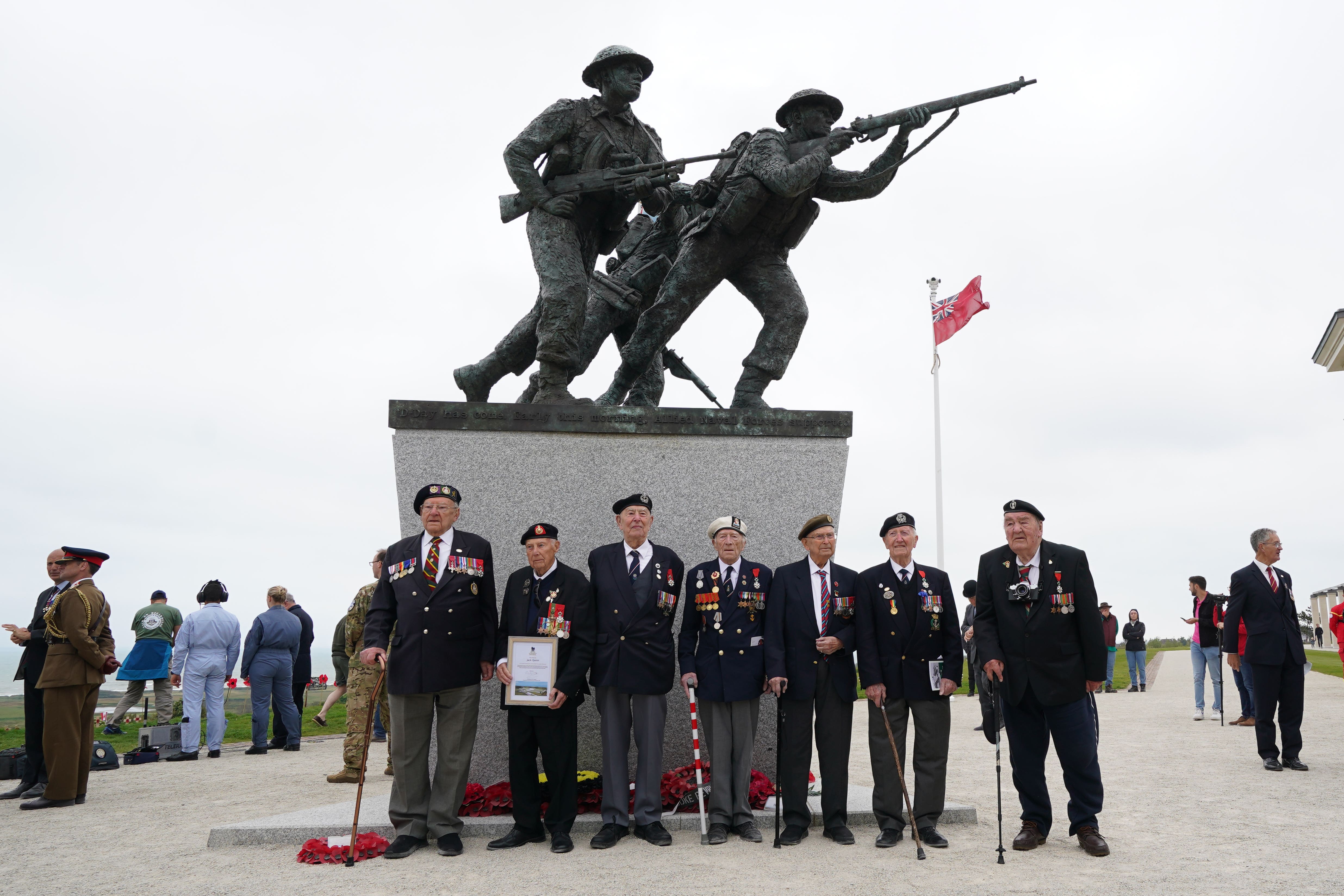 D-Day veterans pose for pictures at the British Normandy memorial statue after the Royal British Legion (RBL) Service of Remembrance to commemorate the 79th anniversary of the D-Day landings, at the British Normandy Memorial in Ver-sur-Mer, Normandy, France. The service remembers the 22,442 servicemen and women from 38 different countries who died under British command on D-Day and during the Battle of Normandy in the summer of 1944. Picture date: Tuesday June 6, 2023.