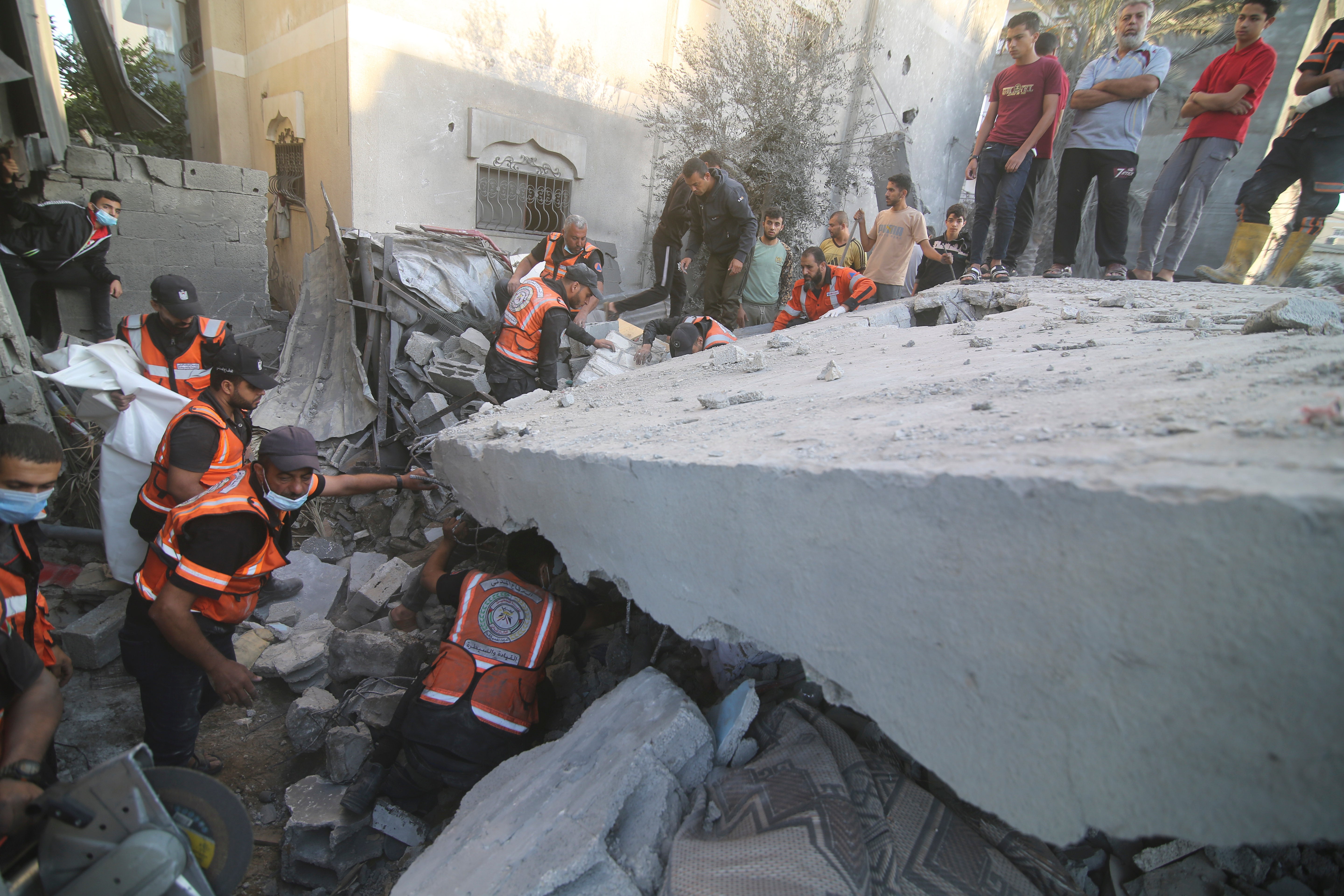 Palestinians search for survivors following airstrikes in the Gaza Strip