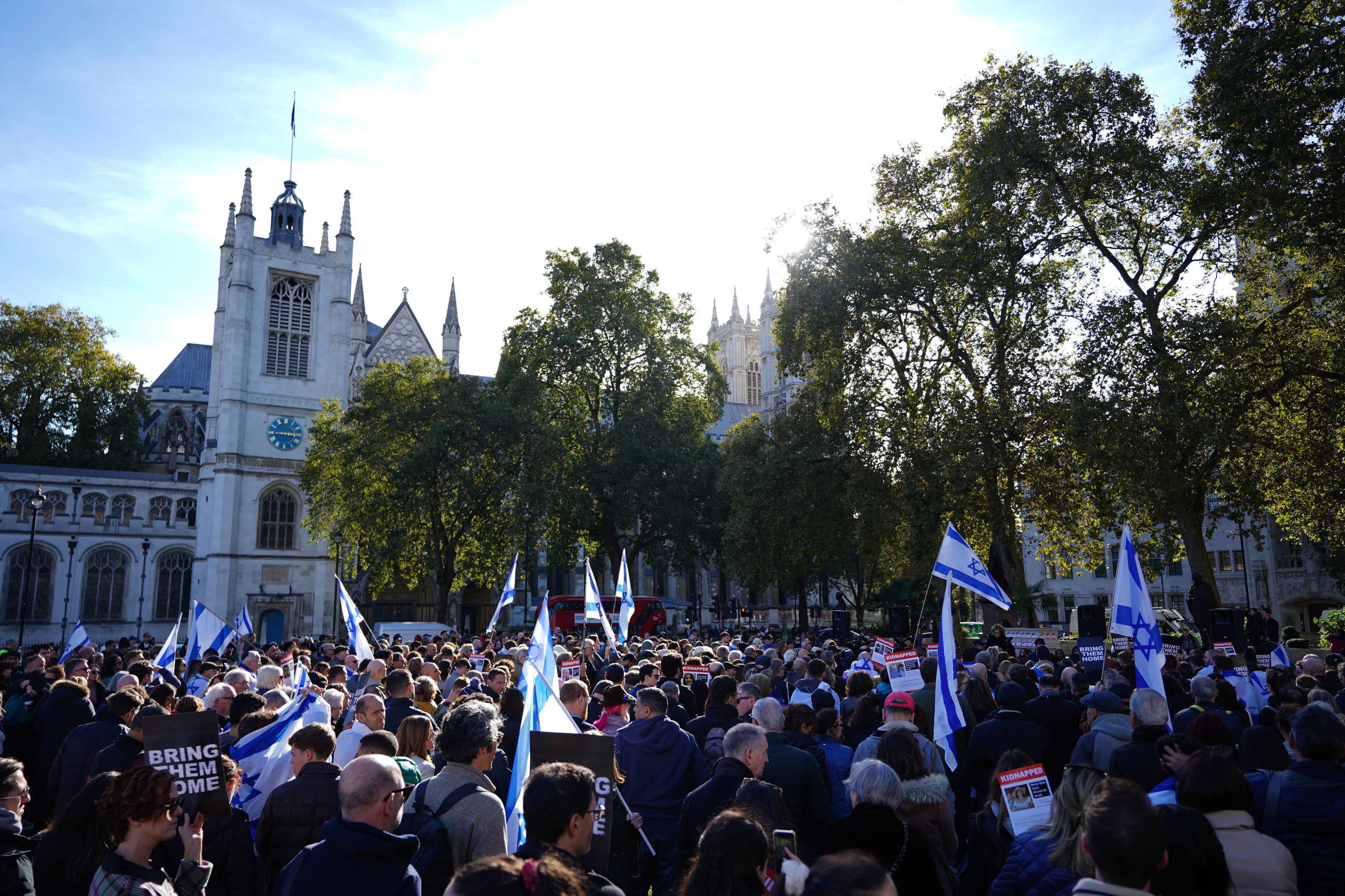 People at a vigil at Parliament Square in London, for victims and hostages of the Hamas attacks.