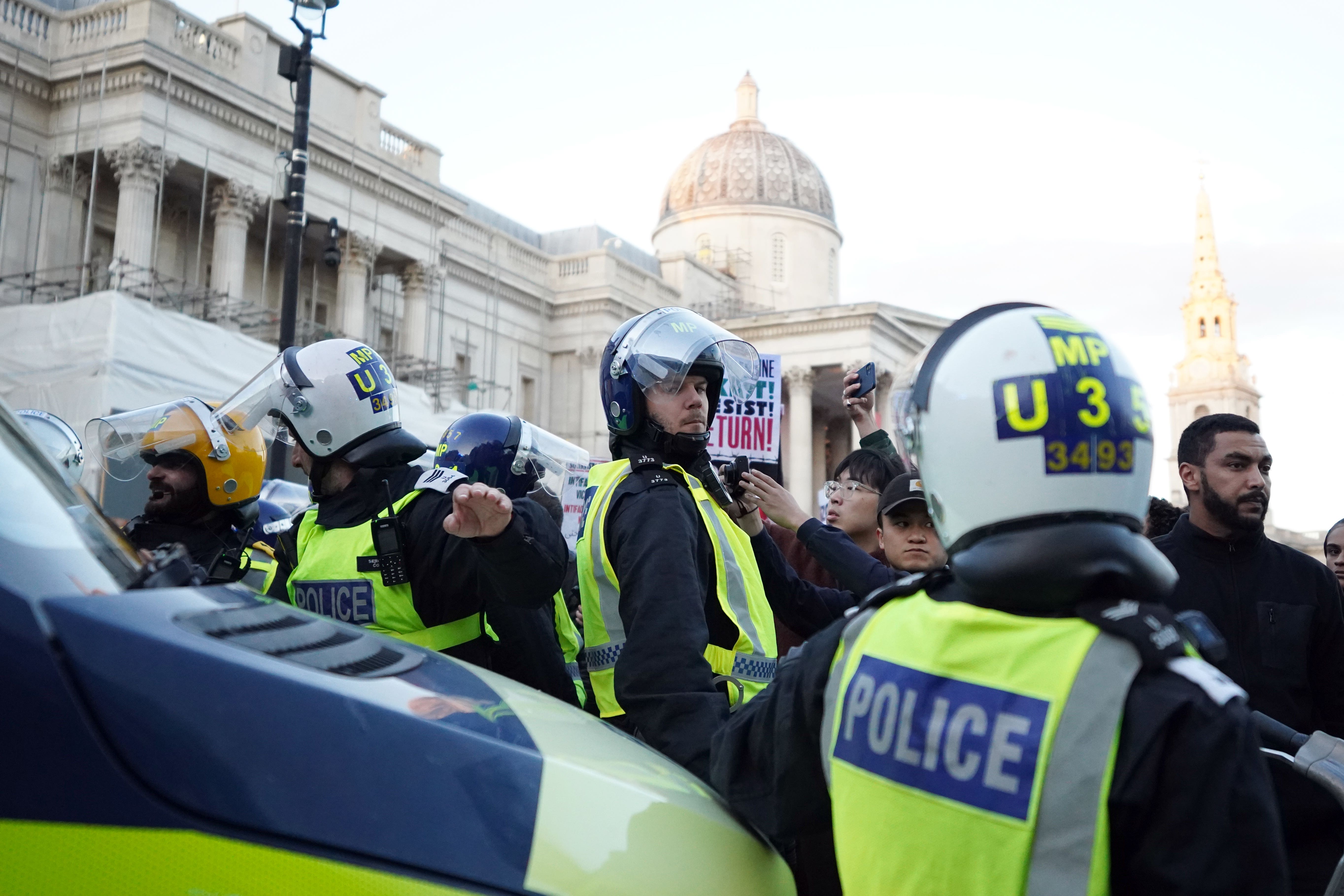 Police officers and protesters clashed in Trafalgar Square during a March for Palestine (PA)