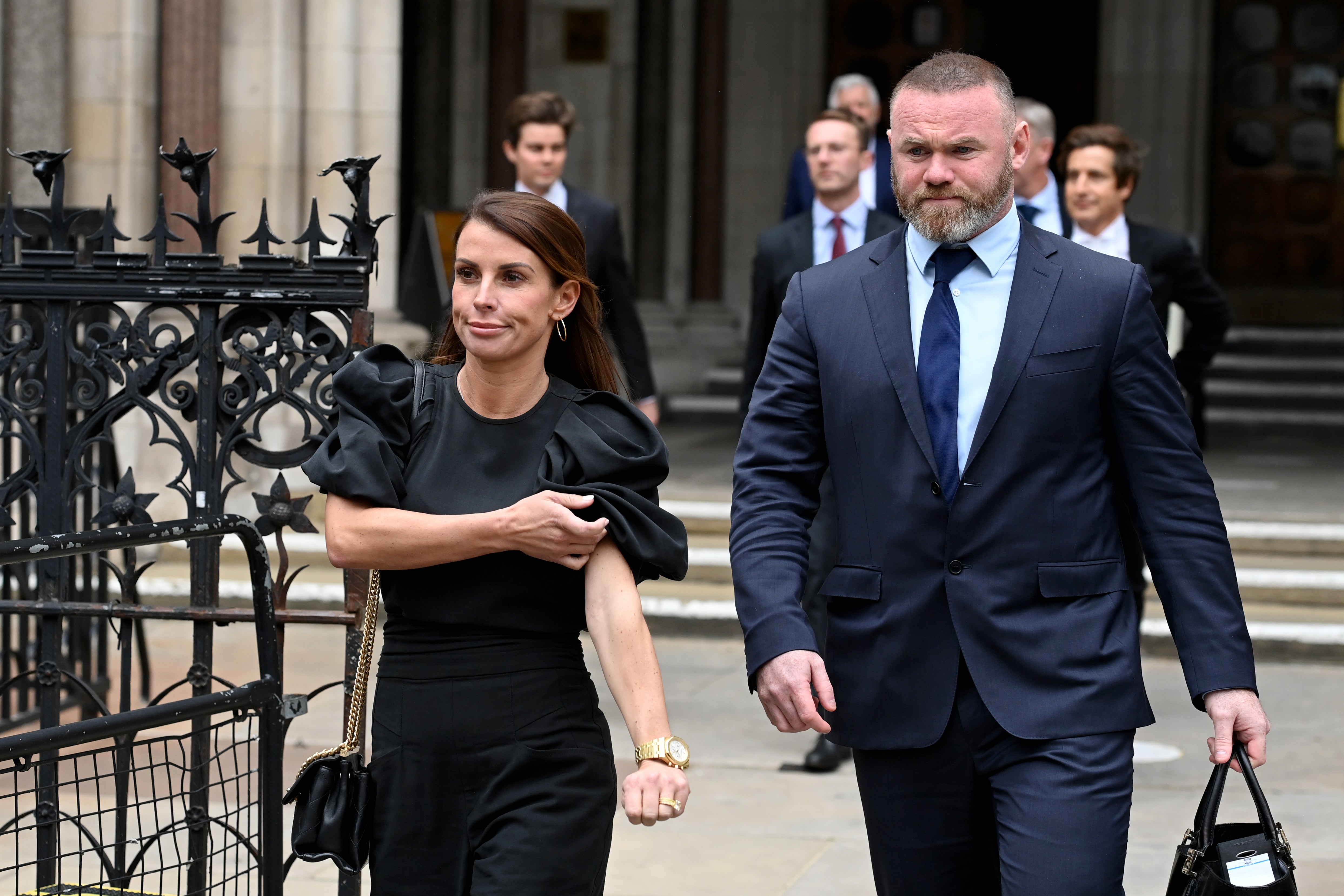 Coleen and Wayne Rooney pictured leaving court during the trial