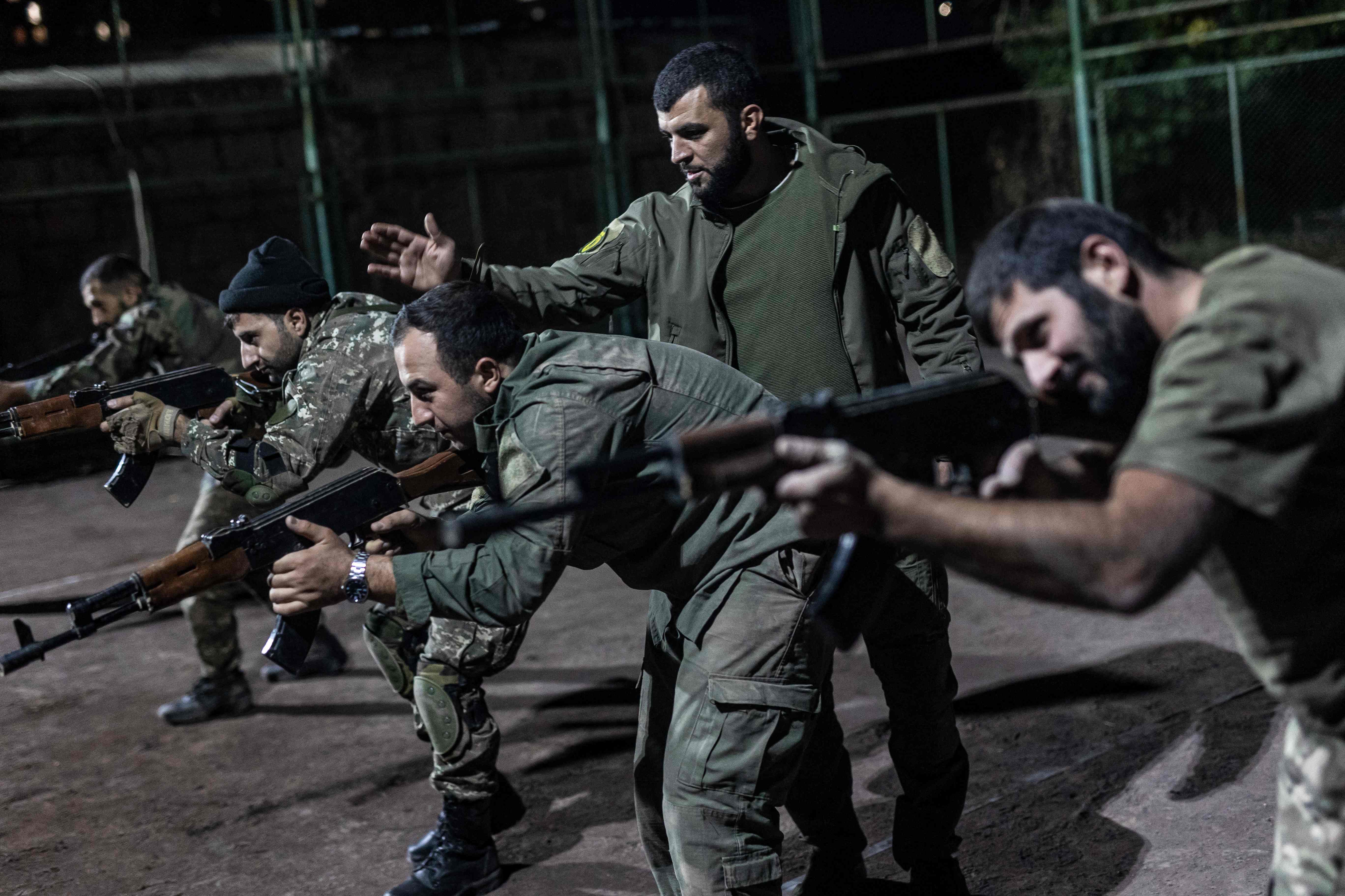 Civilians undergo military training at an outdoor tennis court in Yerevan, in readiness for future conflict with Azerbaijan