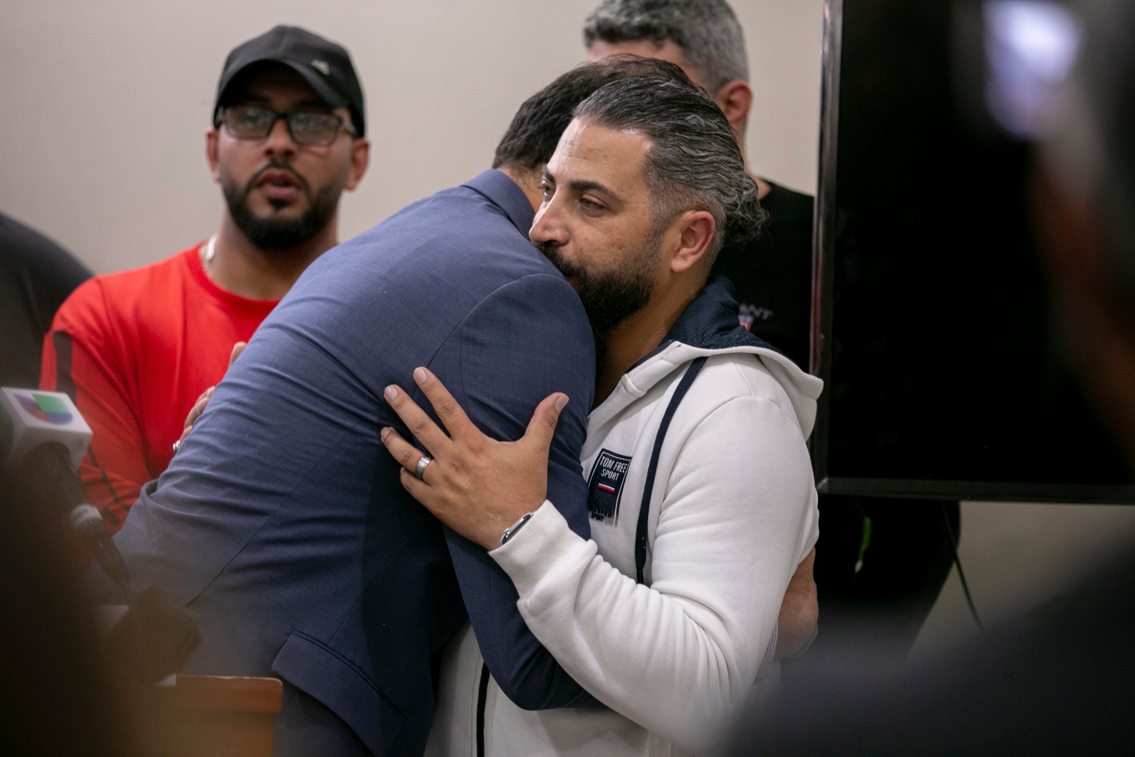 Wadea Al-Fayoume’s father is embraced during a press conference on Sunday.