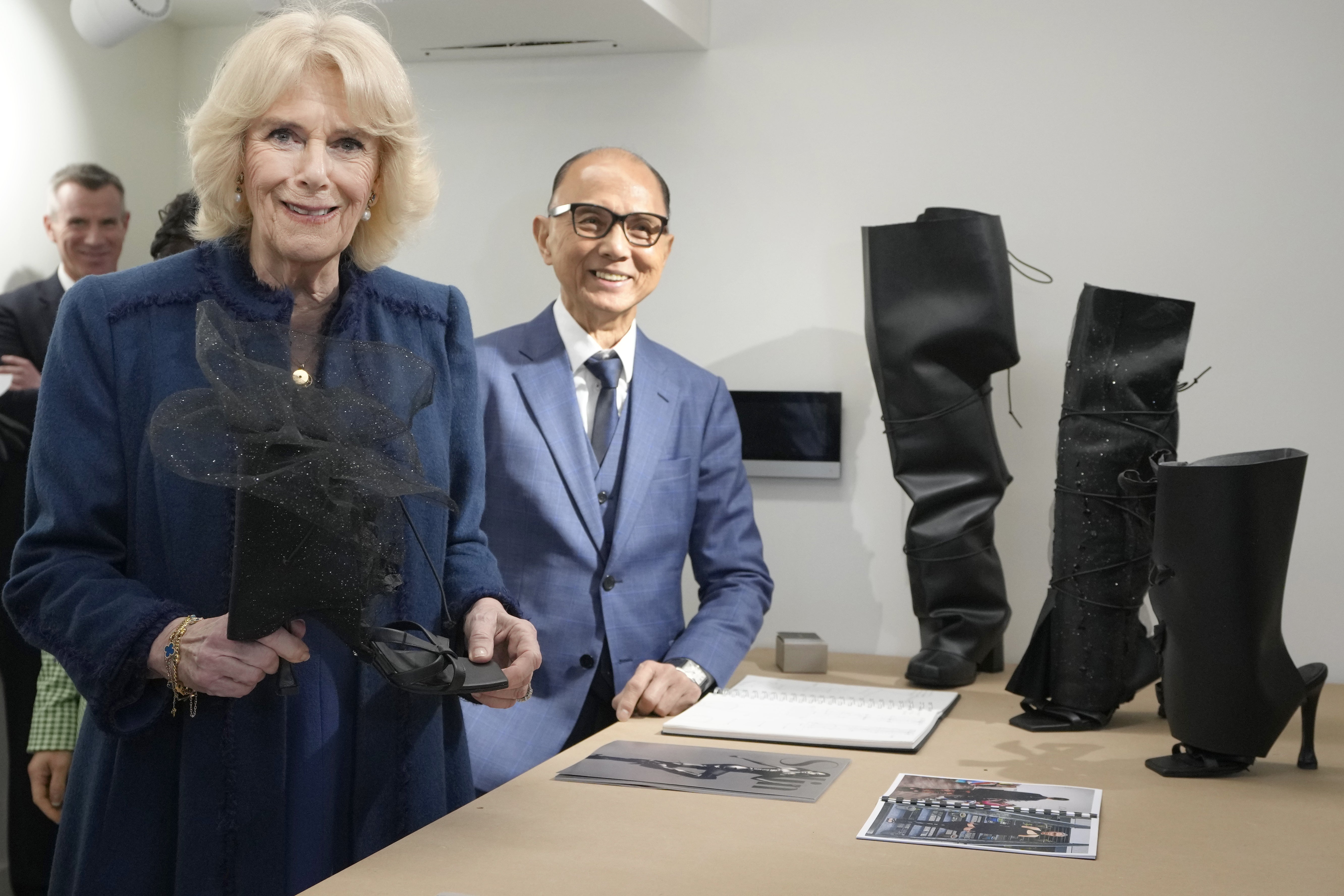 The Queen Consort photographed with Jimmy Choo at the JCA London Fashion Academy in February 2023.