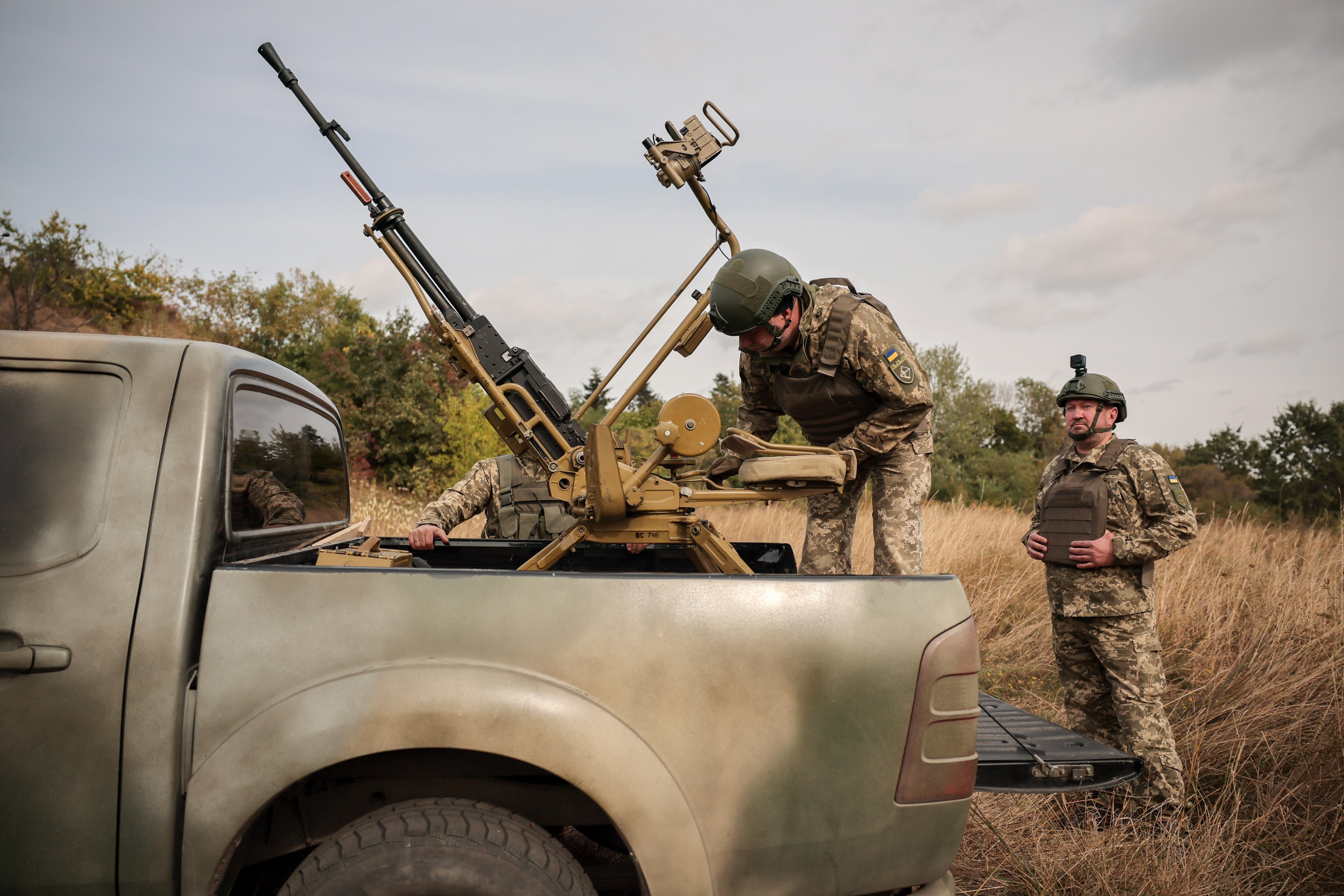 Servicemen load a NSV machine gun during training manoeuvres in Kyiv