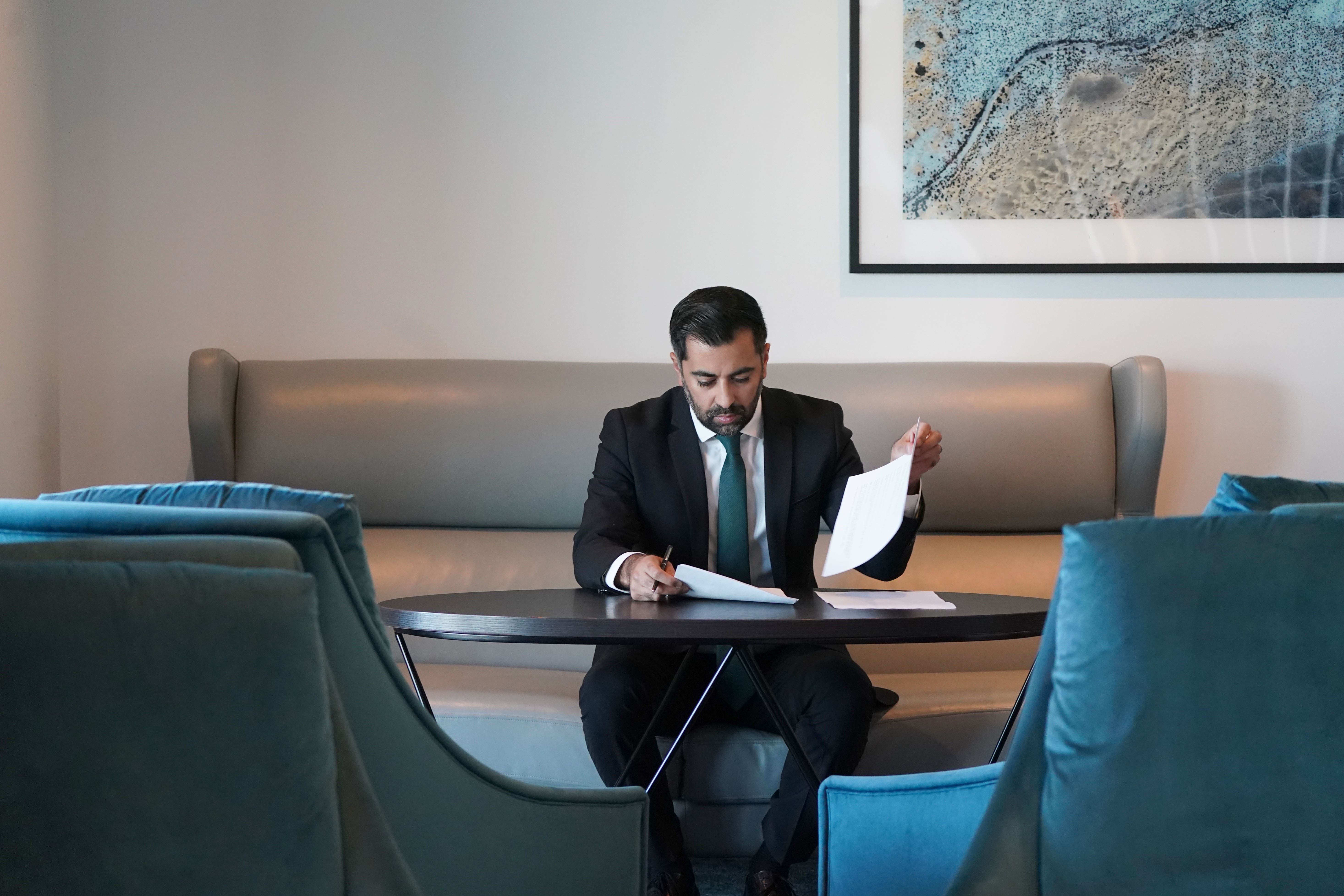 Humza Yousaf looks over his speech prior to delivering it at the SNP annual conference at the Event Complex Aberdeen in Aberdeen (Andrew Milligan/PA)